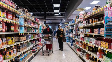 Shoppers browse in a supermarket while wearing masks to help slow the spread of coronavirus disease (COVID-19) in north St. Louis, Missouri, U.S. April 4, 2020.