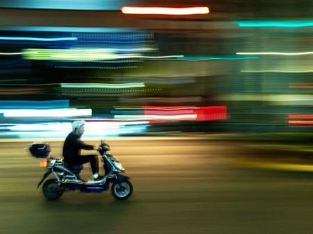 A man rides his scooter in the street in Shanghai, China. Picture taken on November 4, 2025. 