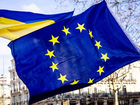 Demonstrators hold the EU and Ukrainian flags on the eve of the third anniversary of the start of Russia's invasion of Ukraine, in Paris, France. Photo taken on February 23, 2025.