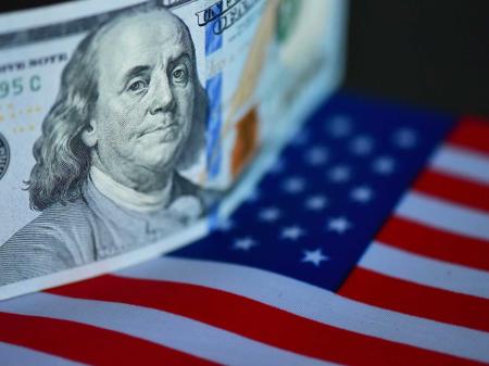 US banknote and flag are displayed in this photo illustration taken on December 11, 2025. 