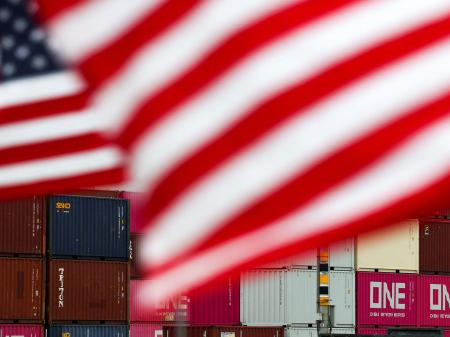 US flags flutter in front of shipping containers at the Port of Long Beach in Long Beach, California. Photo taken on July 11, 2025. 