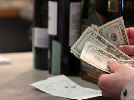 A customer paying for wine at a wine and beer store in Washington, DC. 