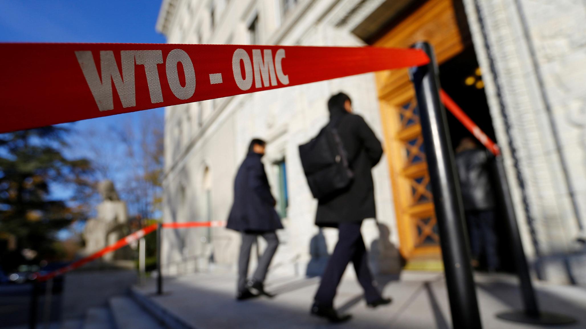 Delegates arrive at the World Trade Organization (WTO) headquarters in Geneva, Switzerland.
