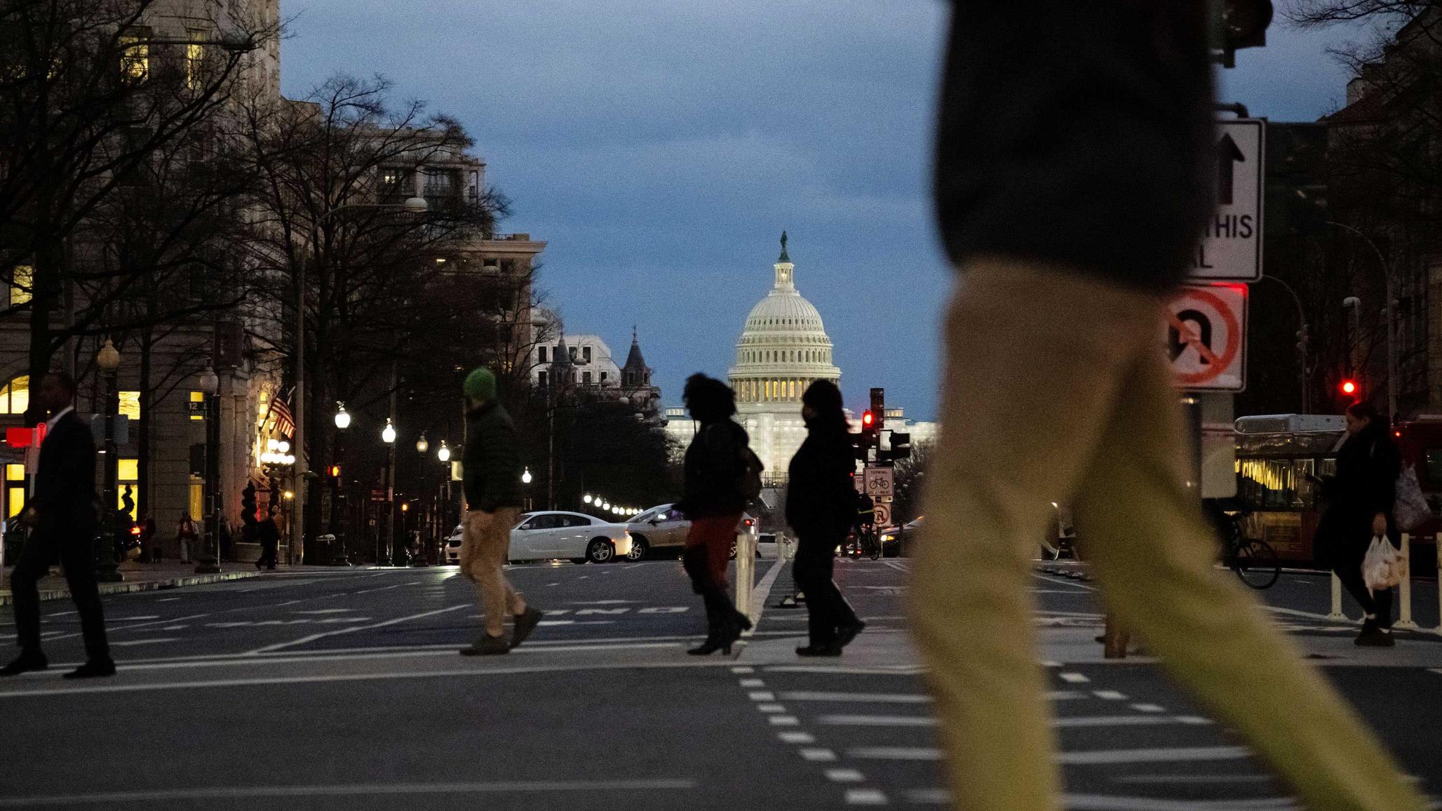 A view of the U.S. Capitol Building with traffic and pedestrians in the foreground, in Washington, D.C., on Thursday, January 26, 2023. 