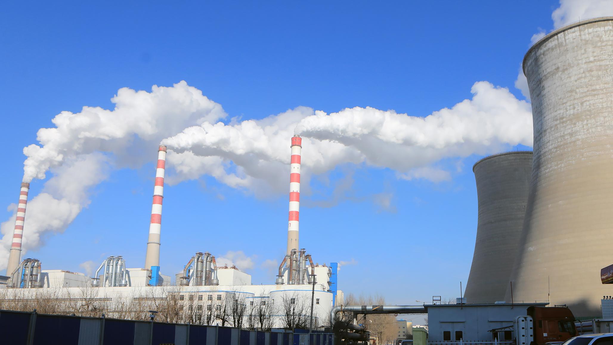 Smoke is discharged from chimneys at a coal-fired power plant.