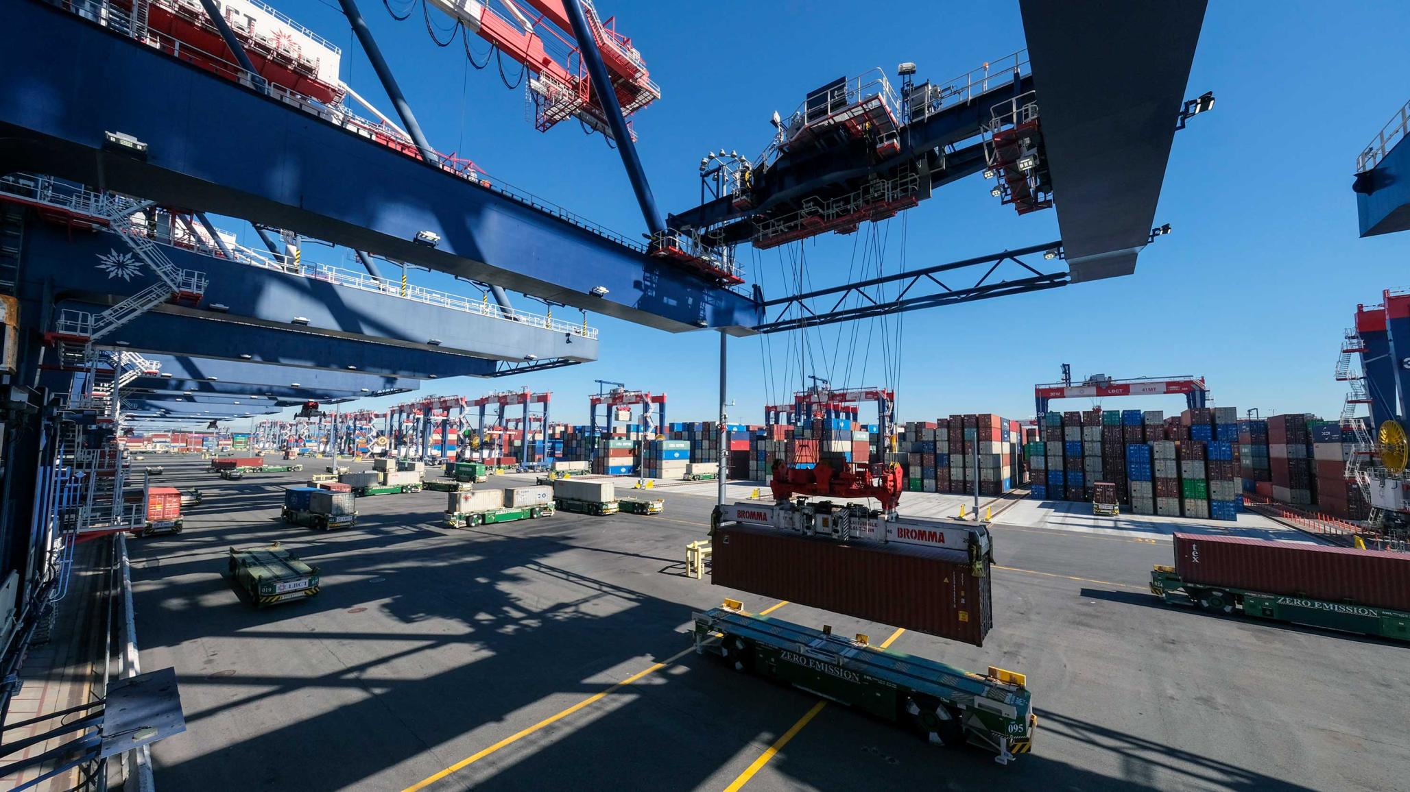 Cargo cranes lift containers from ships in the Port of Long Beach, CA. 