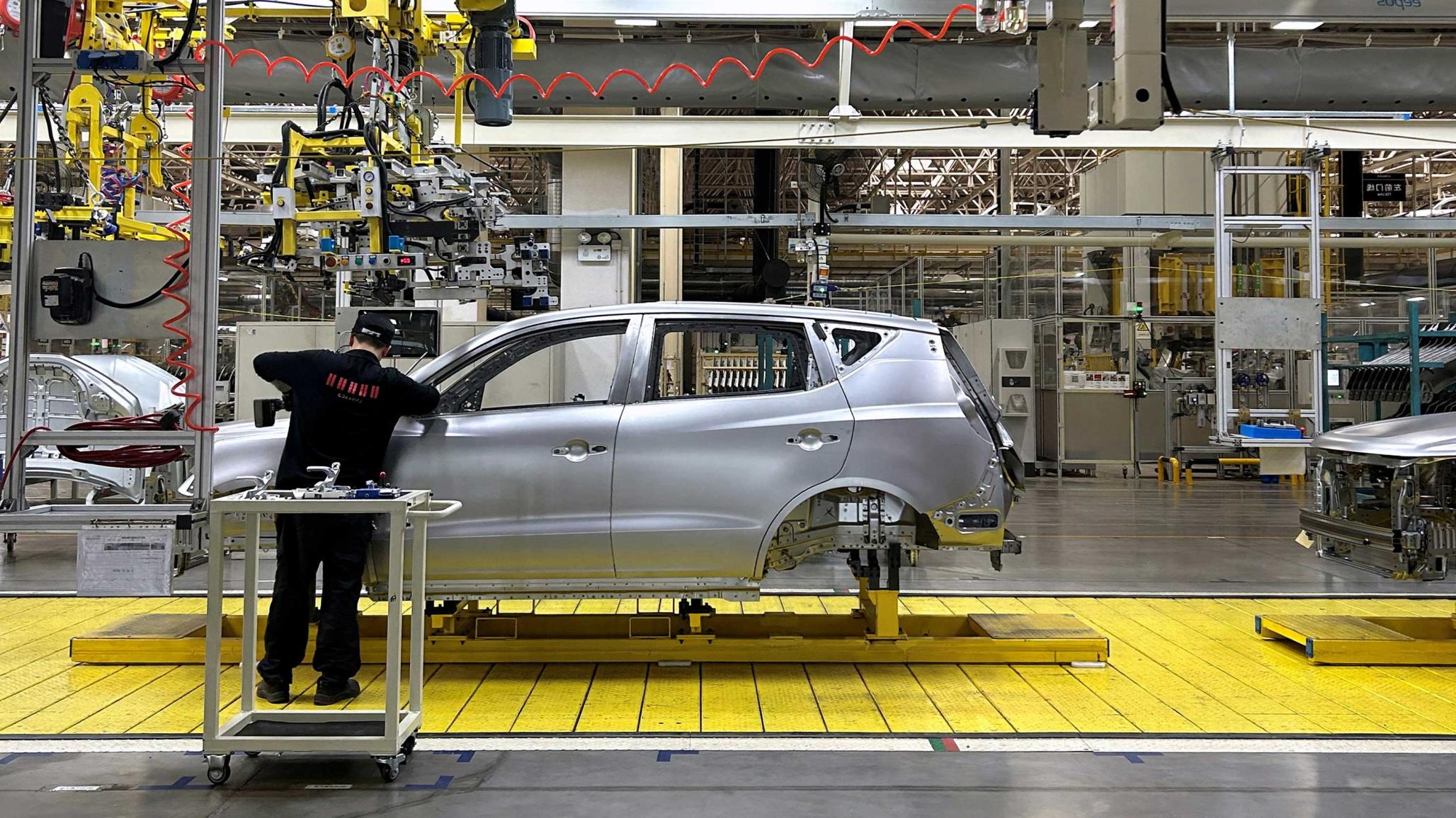 A staff member works on EVs at an assembly line at a manufacturing plant in Chengdu, Sichuan province, China April 13, 2023. 