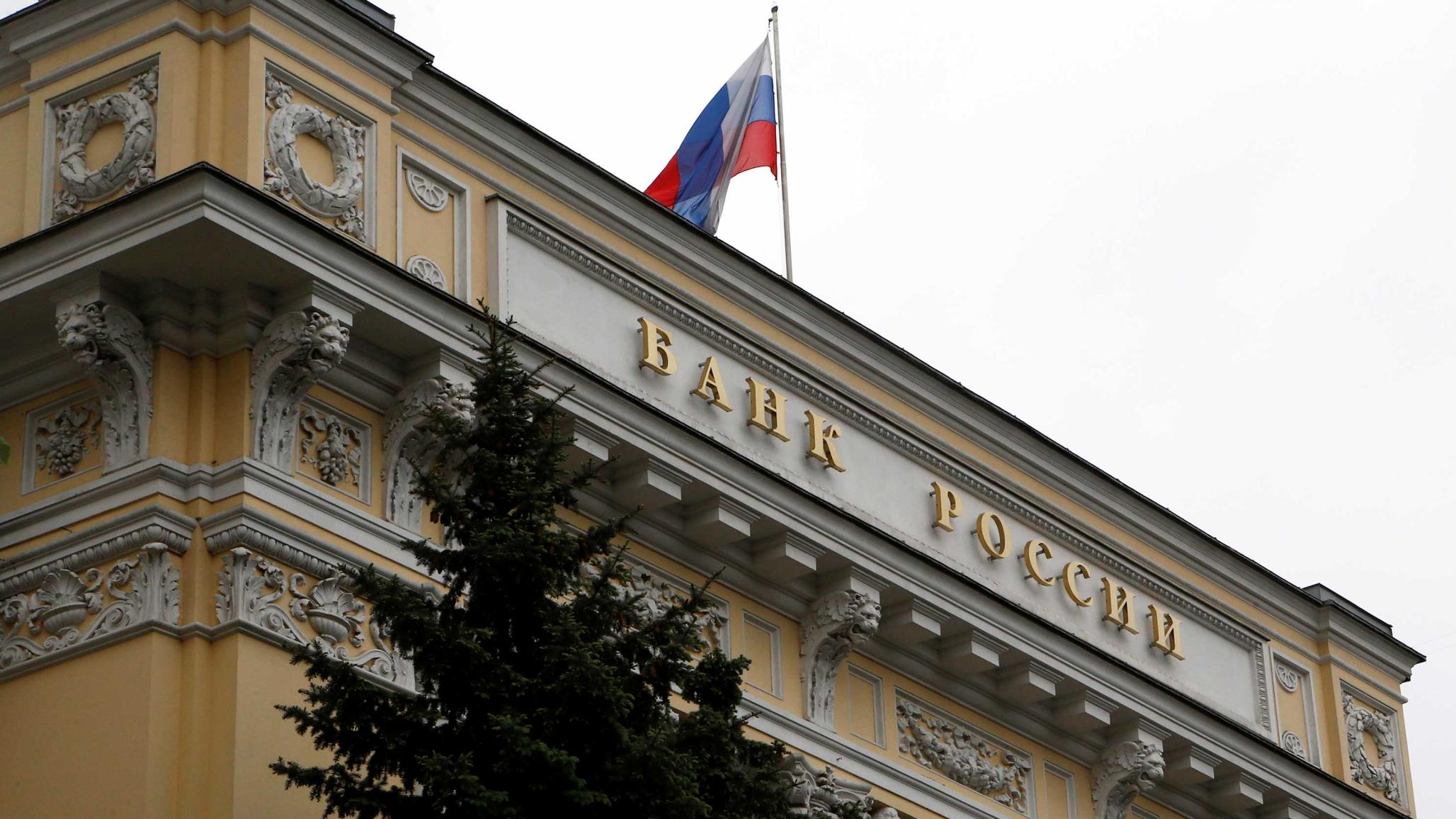 A Russian national flag flies over the Central Bank headquarters in Moscow, Russia. 