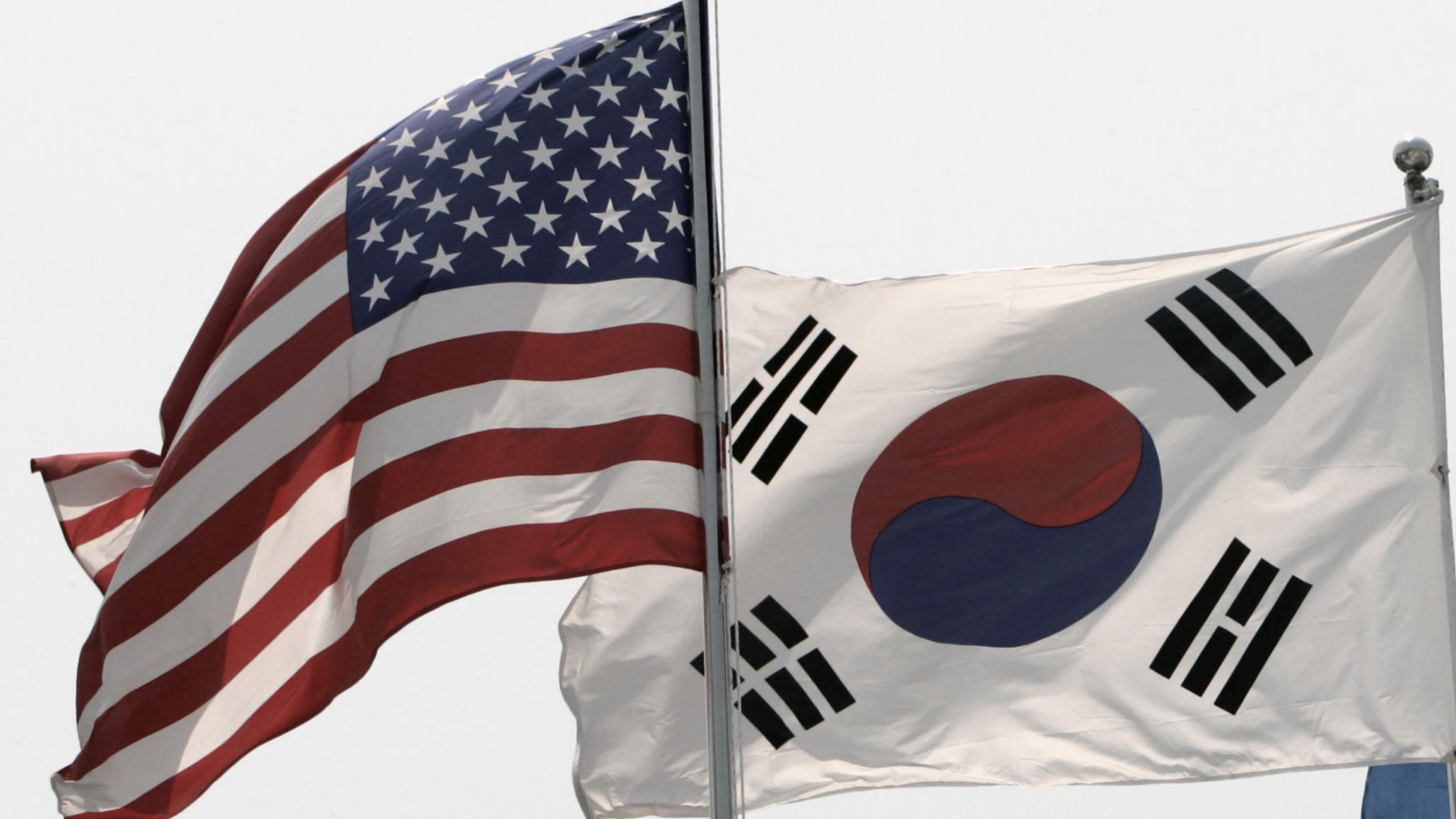 Flags of the US and South Korea flap in the wind in Seoul May 26, 2009. 
