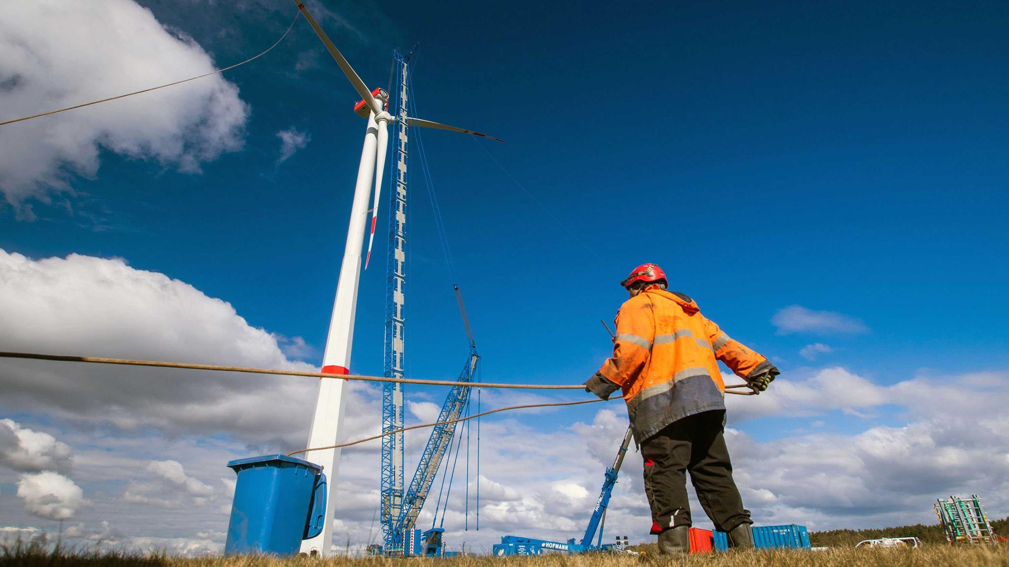 A special crane is used to lift the pre-assembled propeller to the nacelle of a wind turbine in Hoort, Germany. Picture taken March 31, 2020. 