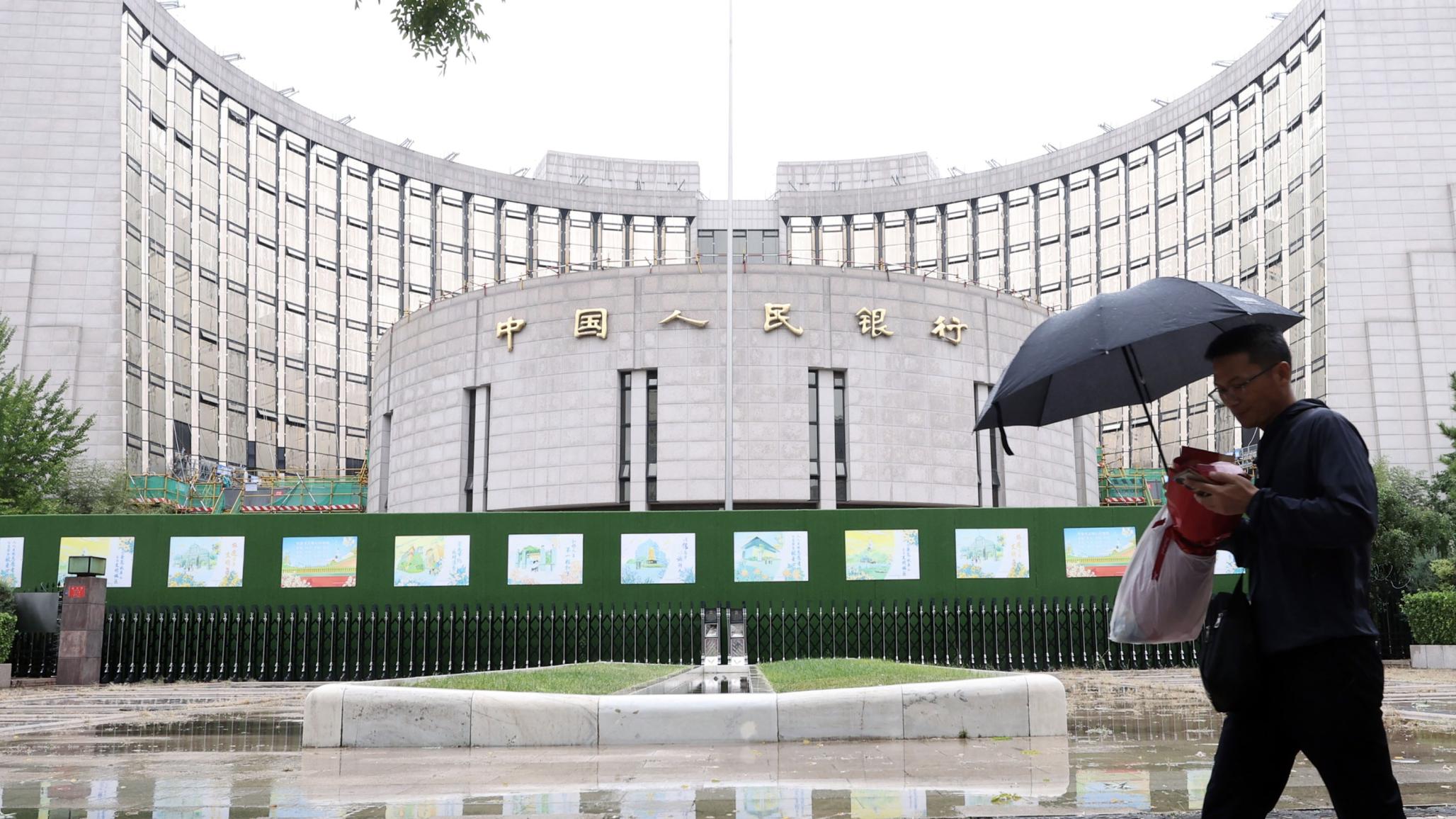 A man walks past the headquarters of the People's Bank of China, the central bank of China, in Beijing, China. Picture taken on September 20, 2024. 