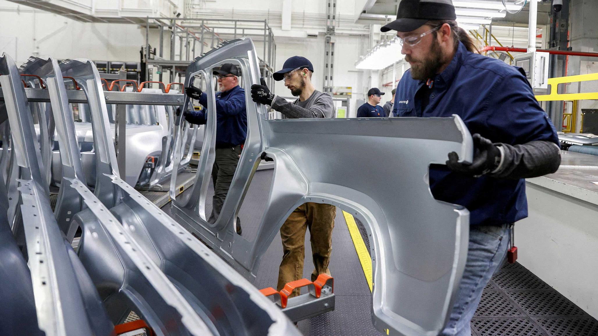 Employees work on an assembly line at a factory in Normal, Illinois, US April 11, 2022. 