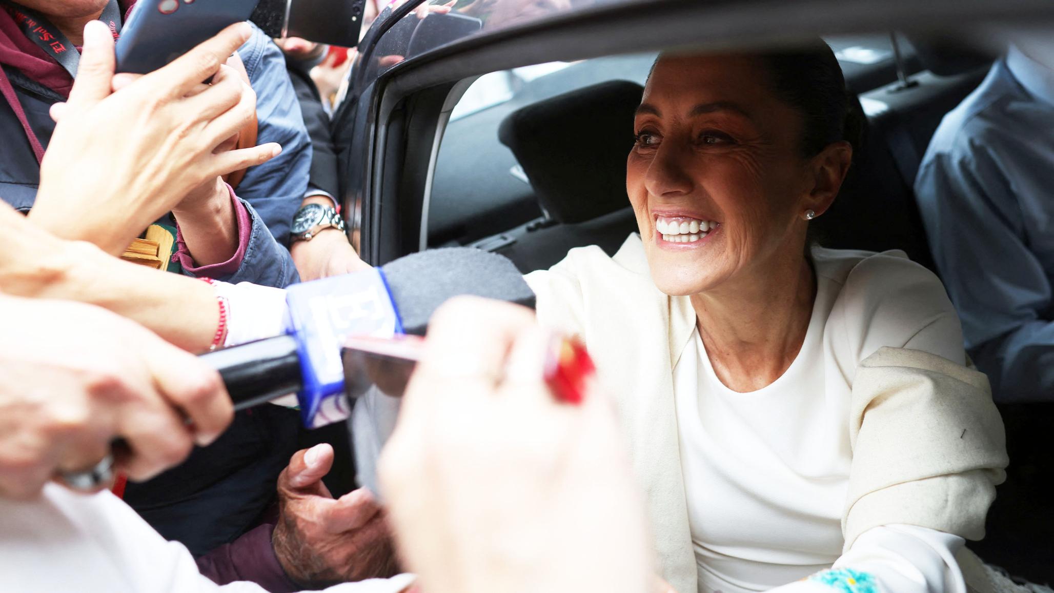 Mexico's President-elect Claudia Sheinbaum greets supporters as she speaks with the media on her way to her swearing-in ceremony, in Mexico City, Mexico. October 1, 2024. 