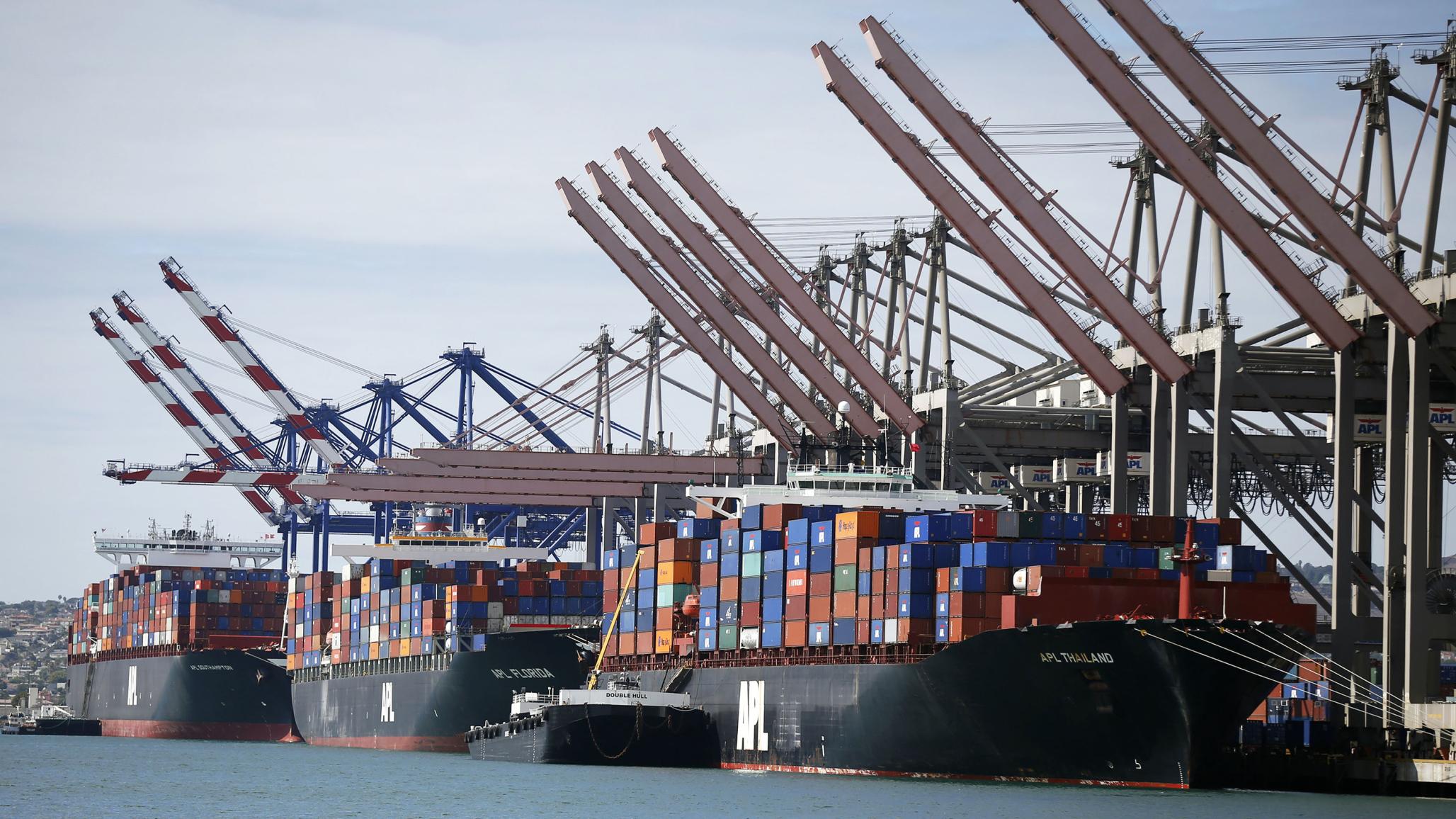 Container ships sit in berths at the Port of Los Angeles, California. 