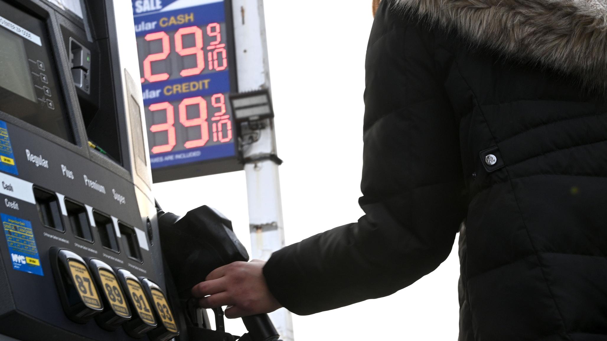A woman at a gas station in Queens, NY during the height of inflation. 