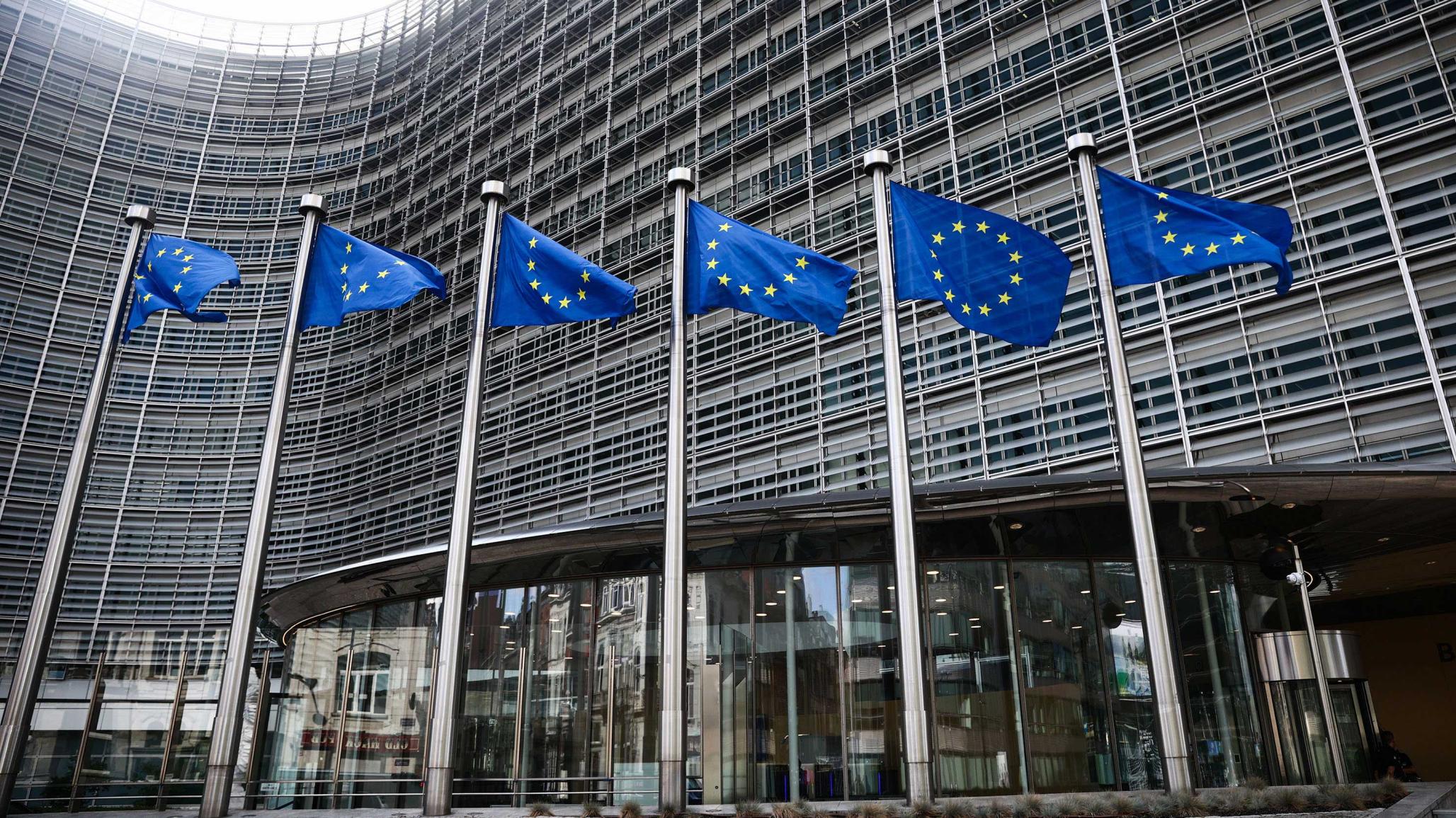 European Union flags are seen in front of the European Commission building in Brussels, Belgium. 