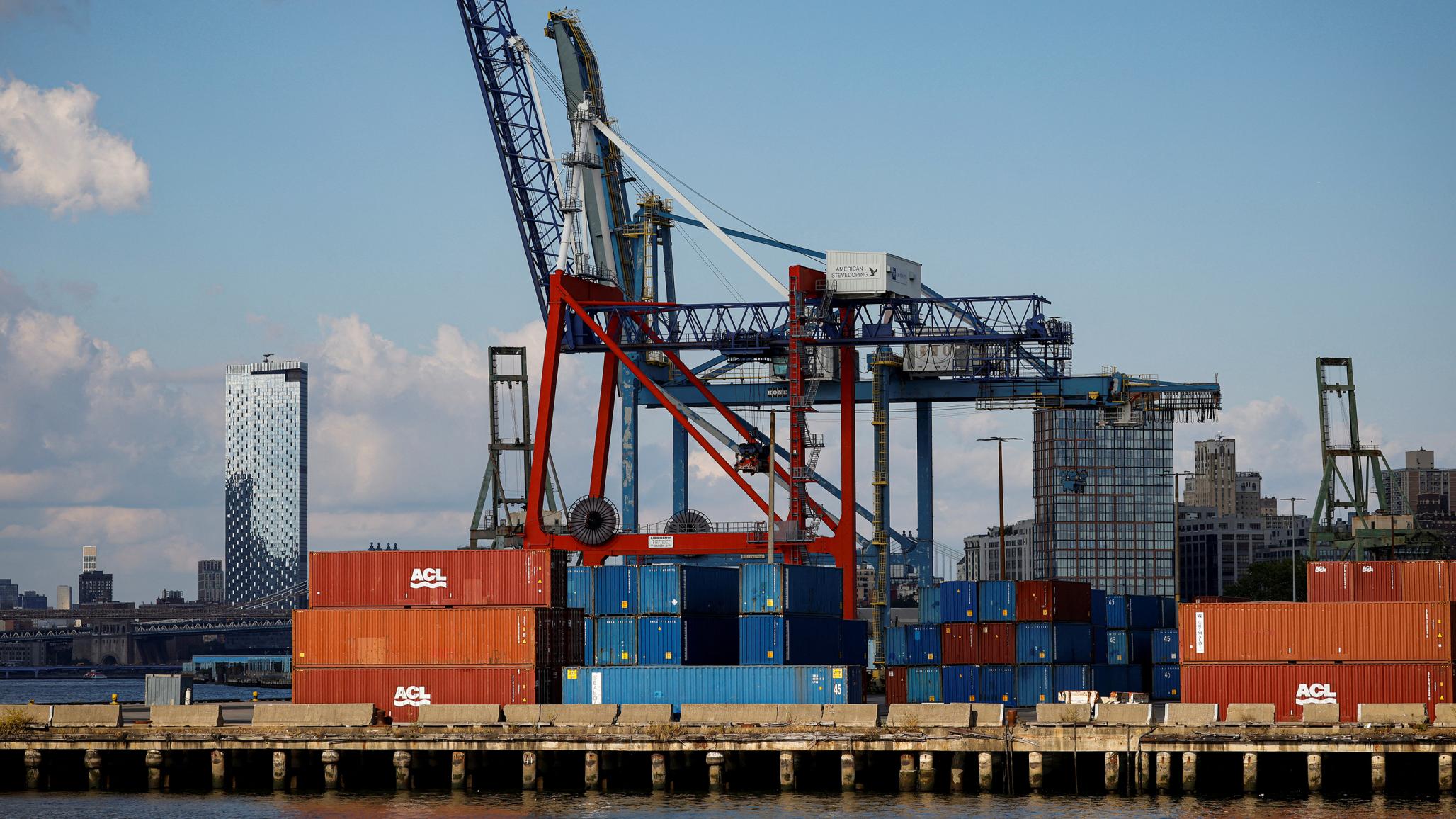 Shipping containers are stacked on a pier at the Red Hook Terminal in Brooklyn, New York, US, September 20, 2024. 