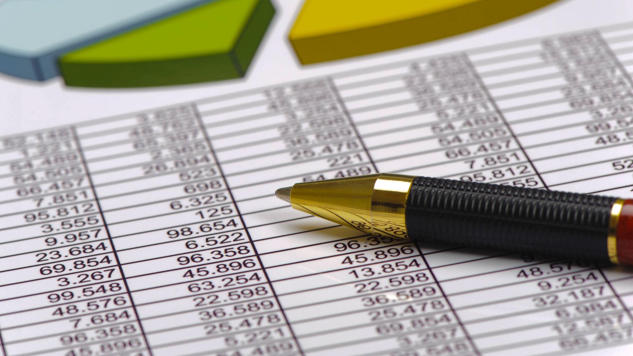 Calculations of finances and a ballpoint pen are shown in this photo illustration. 