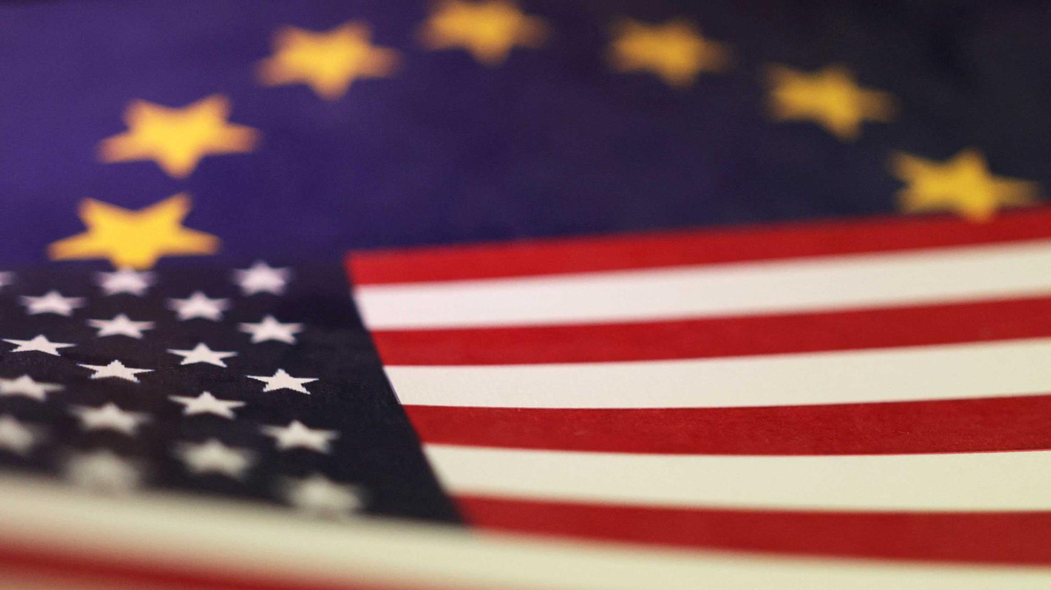 US and EU flags are seen in this photo illustration taken April 10, 2025. 