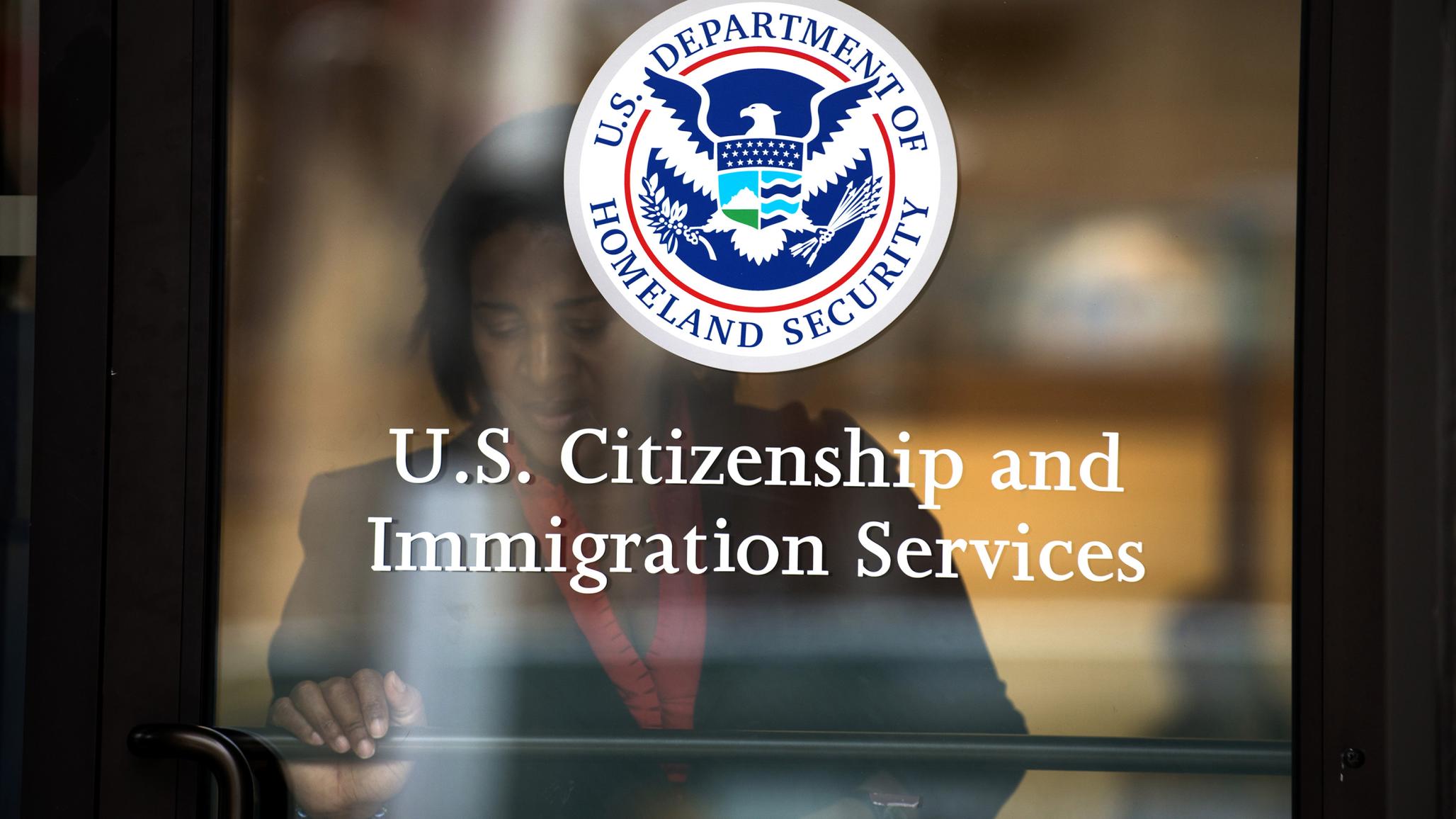 A woman leaves the US Citizenship and Immigration Services offices in New York. 