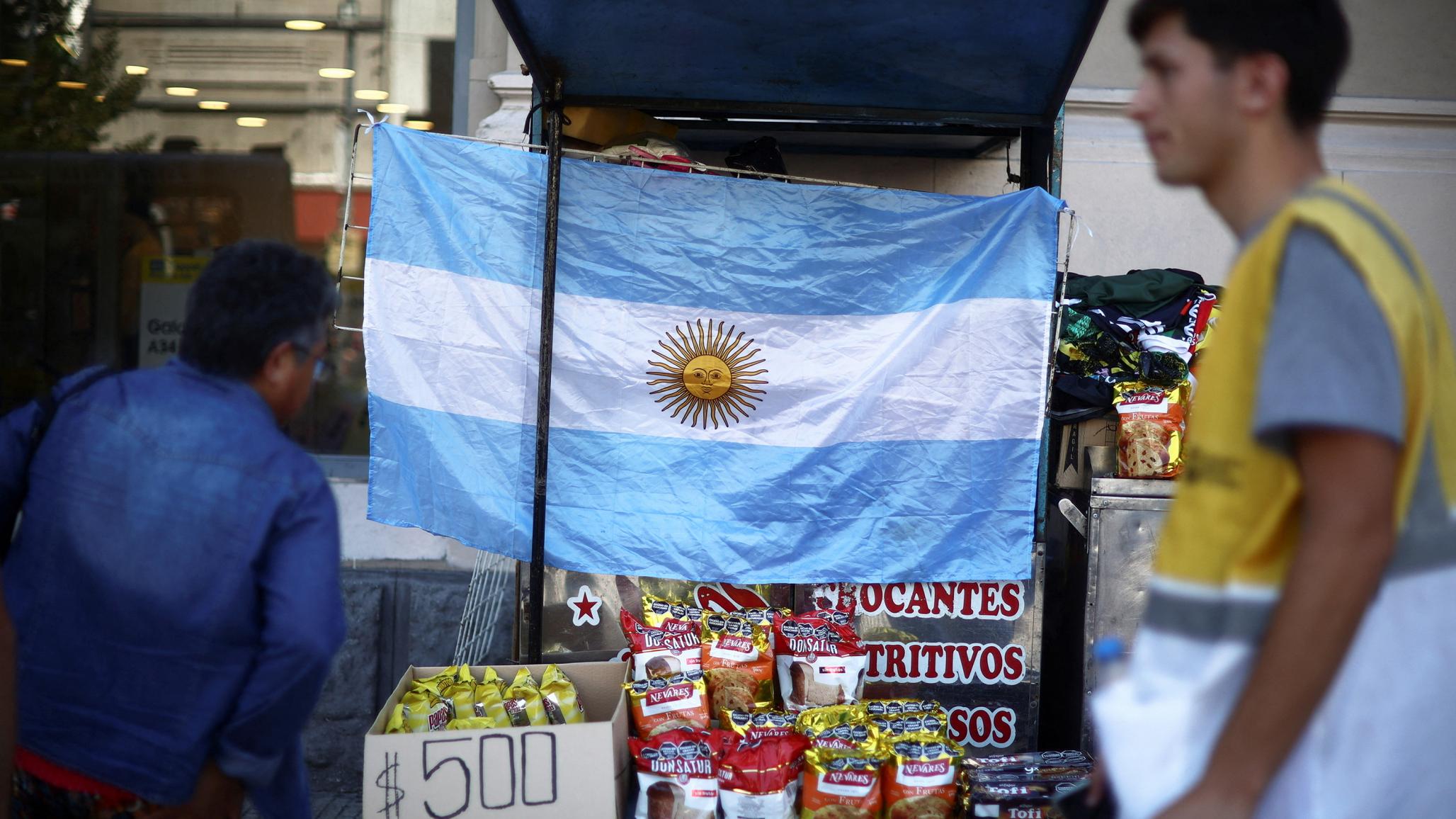 People walk by a store selling snacks in Buenos Aires, Argentina. Picture taken in December 2024. 