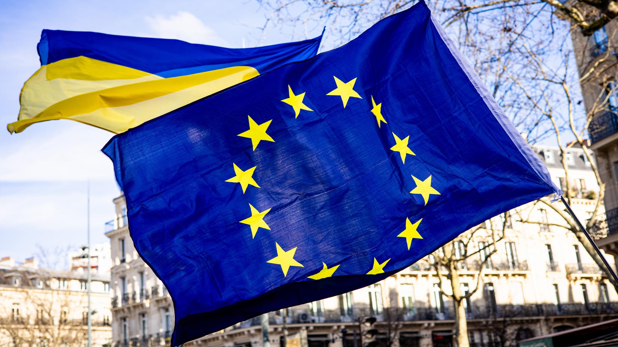 Demonstrators hold the EU and Ukrainian flags on the eve of the third anniversary of the start of Russia's invasion of Ukraine, in Paris, France. Photo taken on February 23, 2025.