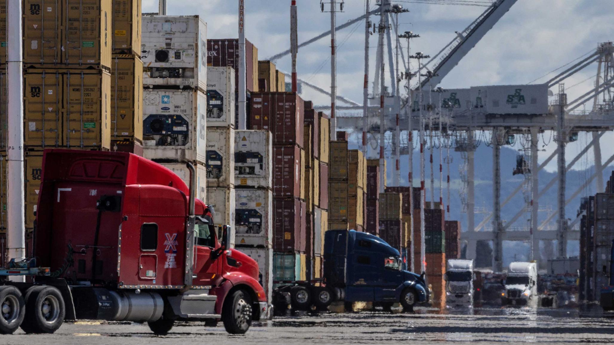 Shipping containers and trucks are seen at the port in Oakland, CA as trade tensions escalate over US tariffs. Picture taken on March 6, 2025. 