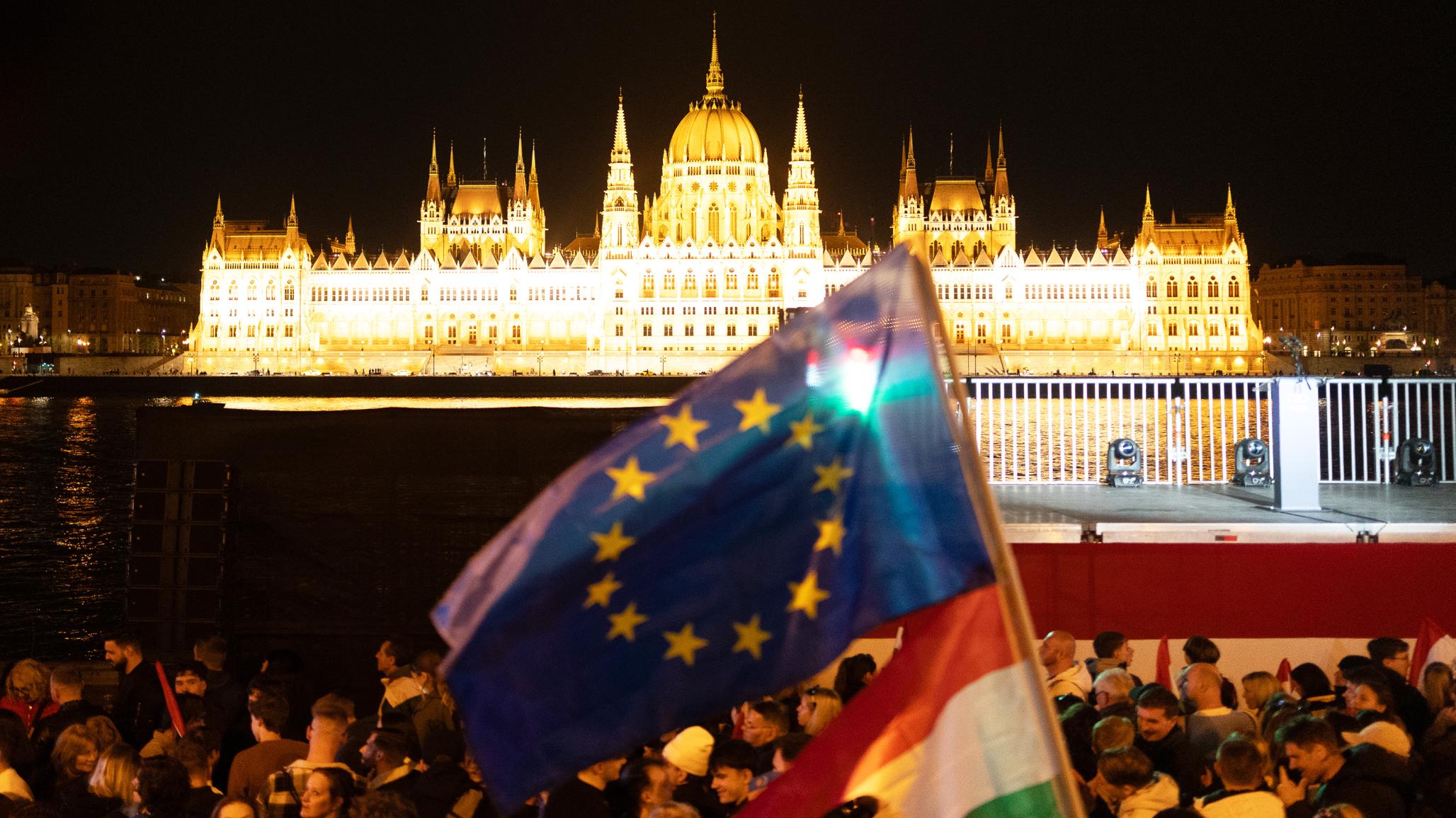 A Tisza Party supporter waves the EU and Hungarian flags outside the Hungarian parliament in Budapest, Hungary. Photo taken on April 12, 2026. 