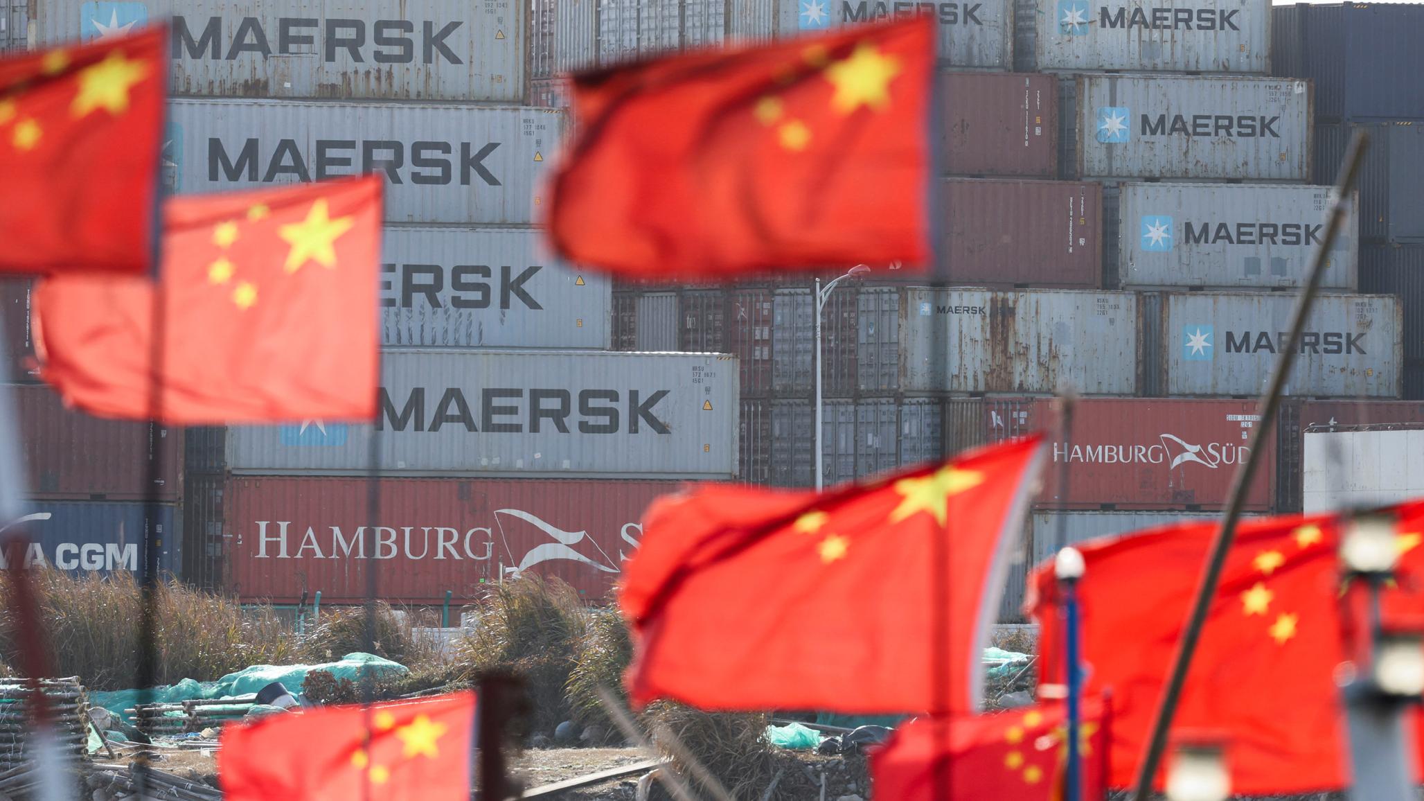 Chinese national flags flutter near shipping containers at the Yangshan Port outside Shanghai, China. Photo taken on February 7, 2025. 