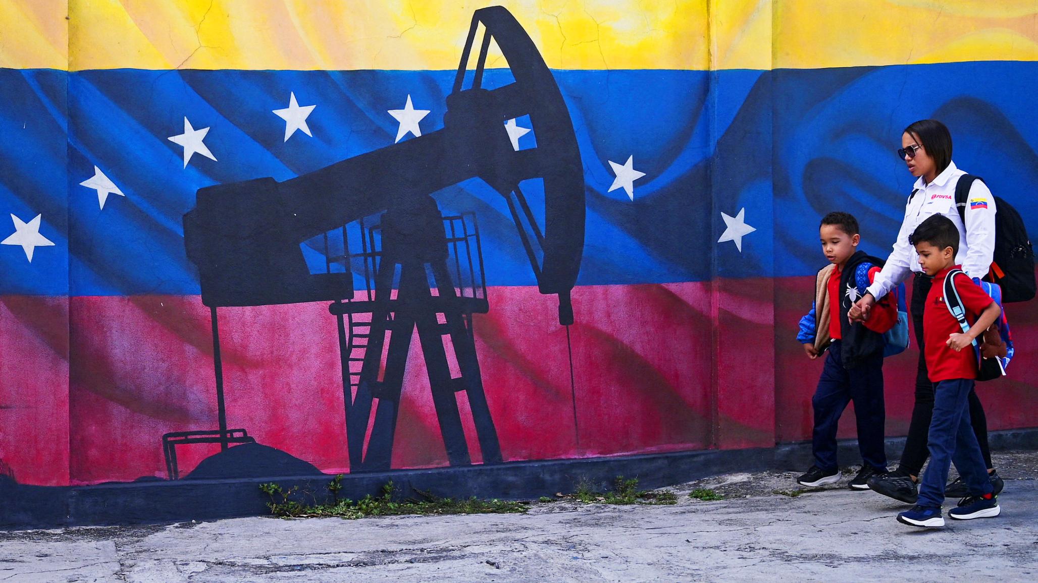 People walk in front of a mural of an oil pump on Venezuela's national flag, near the headquarters of the state-run oil company PDVSA, in Caracas, Venezuela. Picture taken on January 13, 2026. 