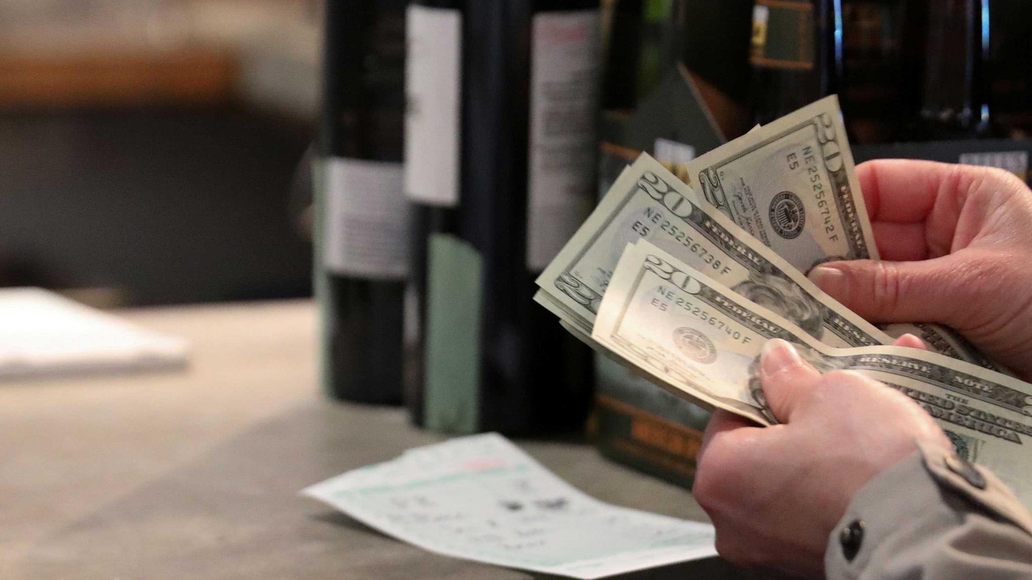 A customer paying for wine at a wine and beer store in Washington, DC. 