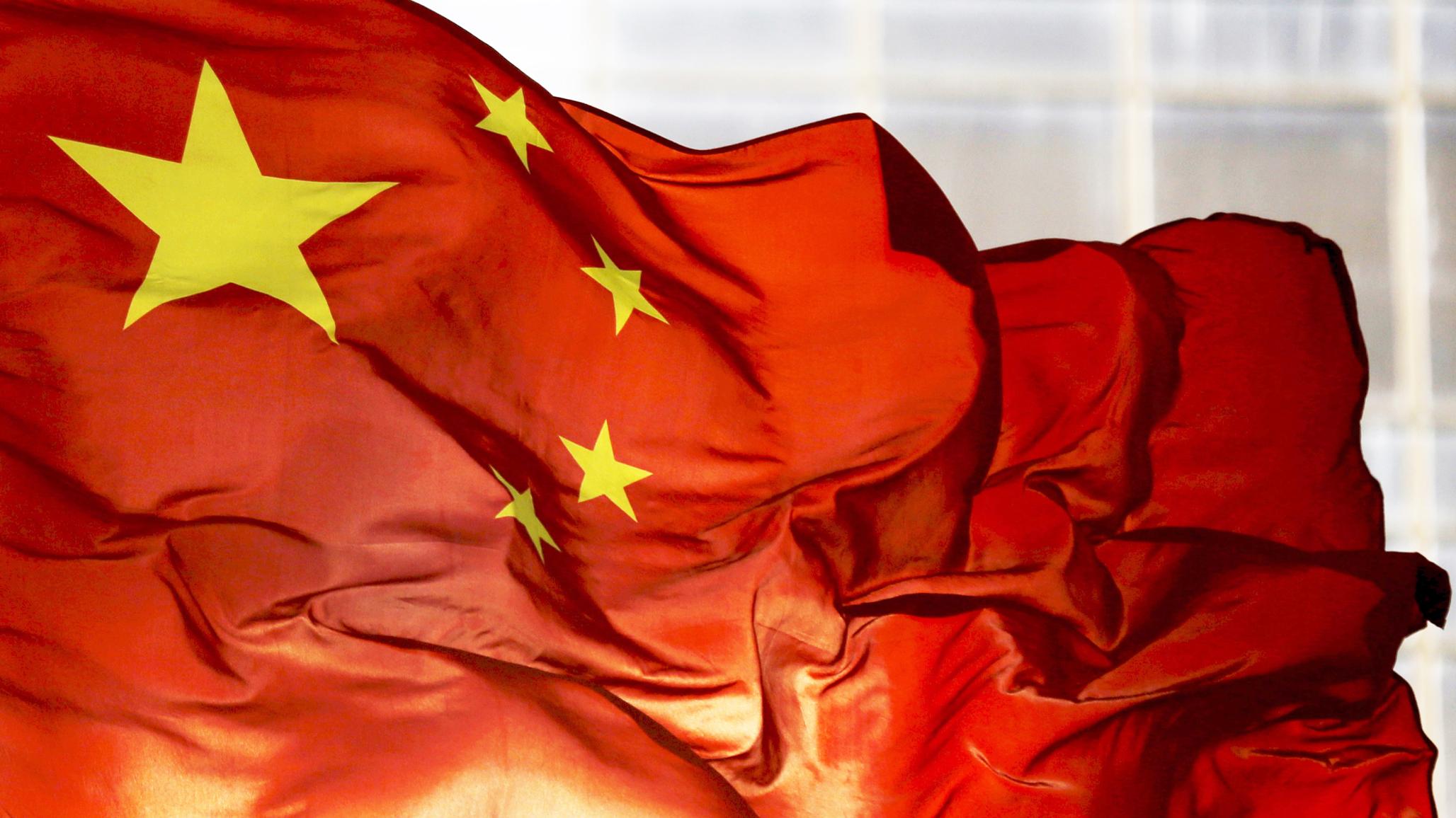 China's national flag flutters at a business district in Beijing, China. 