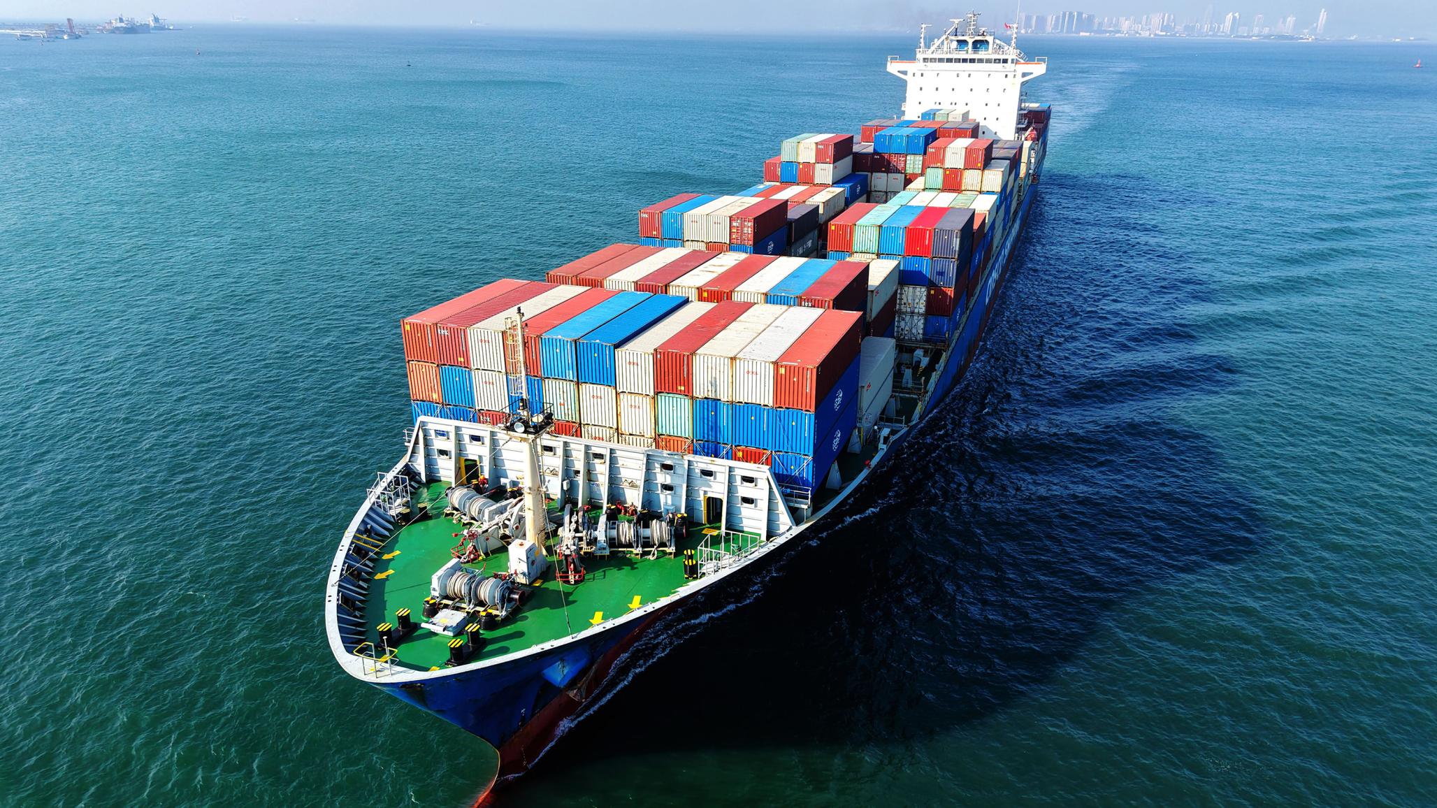 A Chinese cargo ship loaded with foreign trade containers is en route from Shandong Province, China. July 2026. 