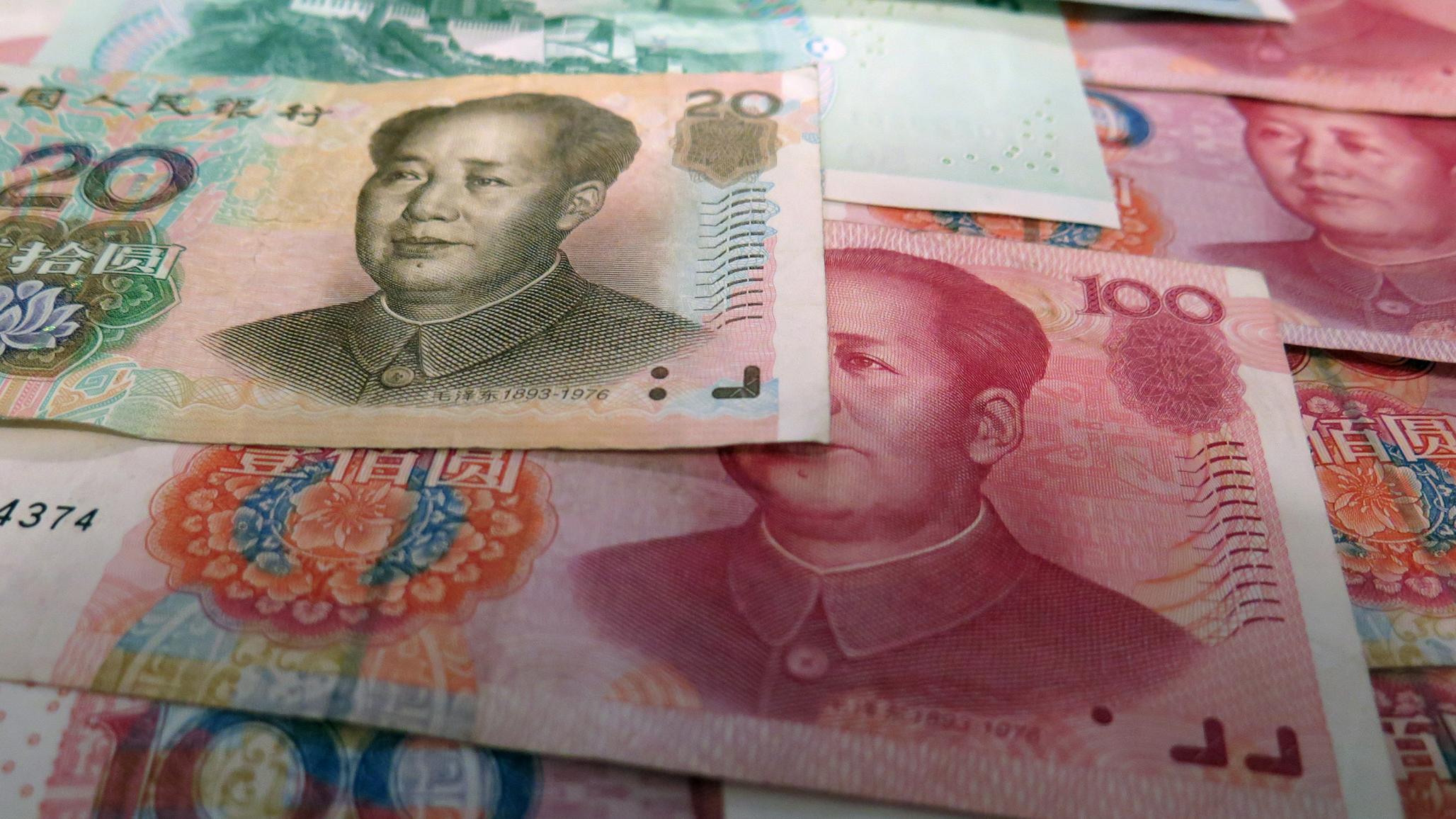 Yuan banknotes are displayed in this photo illustration. 
