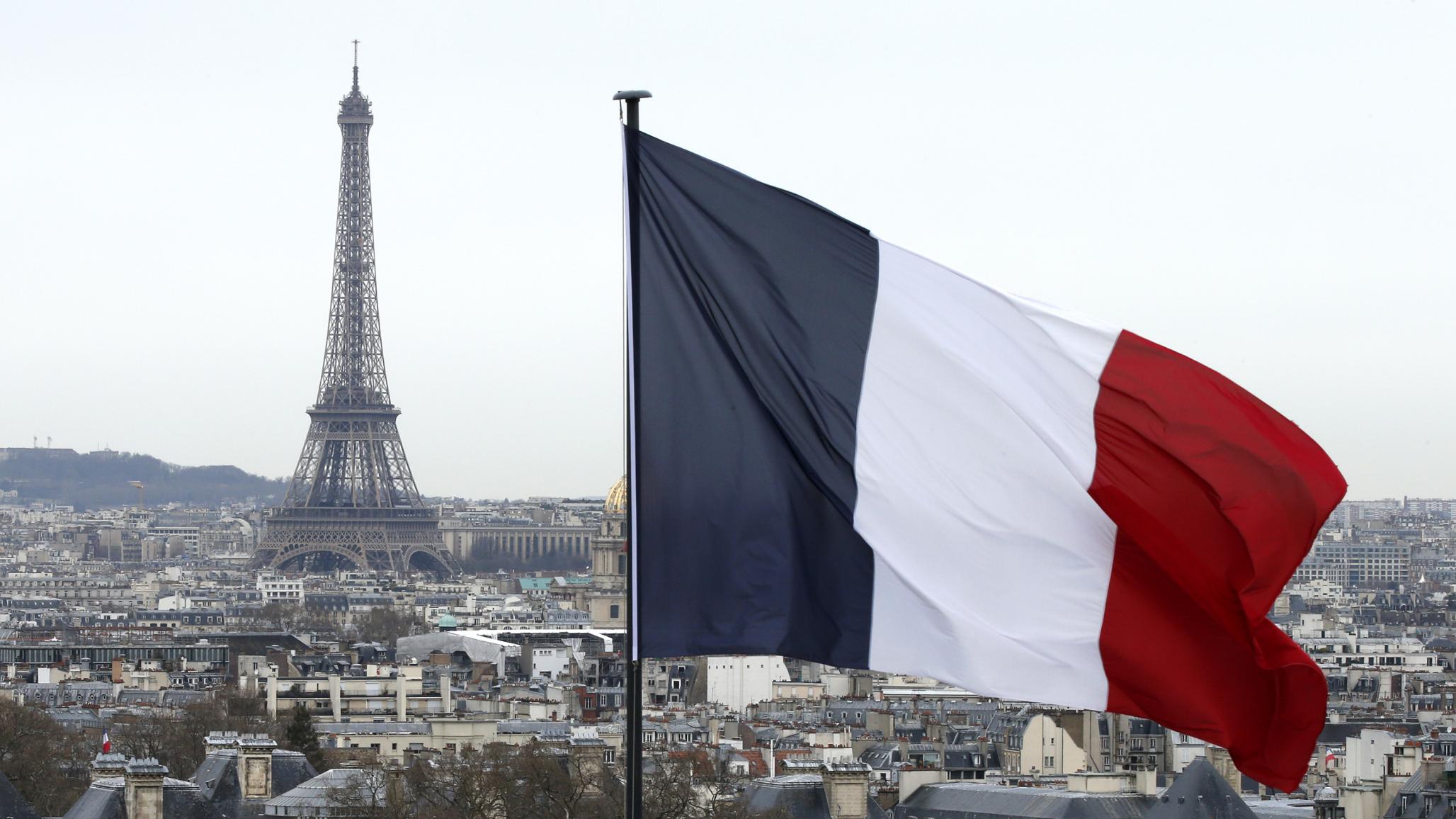 A city view shows the French flag and the Eiffel Tower in Paris, France. March 2016. 