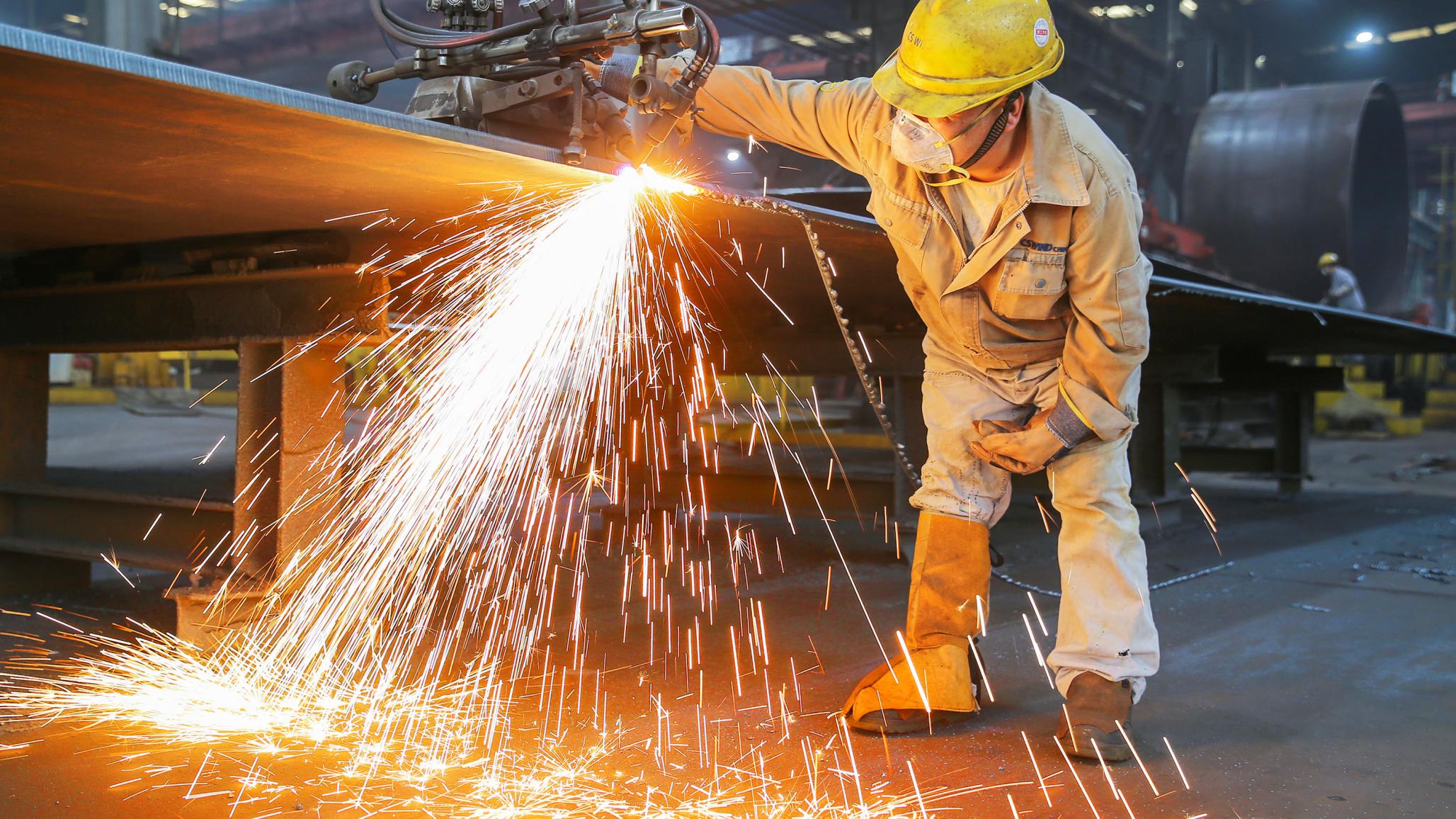 A worker oversees production at wind power equipment company in Jiangsu Province, China. October 2025. 