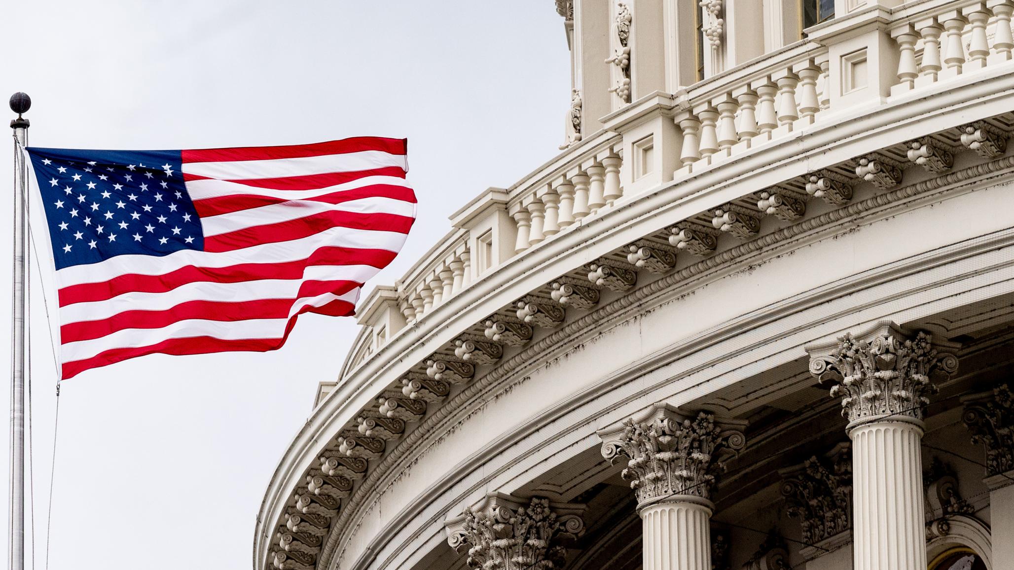 The American flag flies above the US Capitol in Washington, DC. March 2022. 