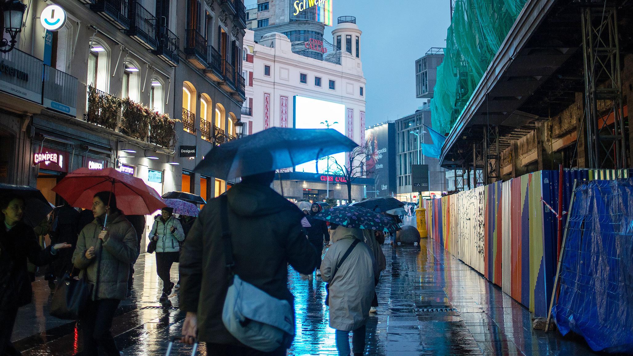 On a rain-soaked city street in southern Europe, commuters and construction crews keep the economy moving. March 2025. 