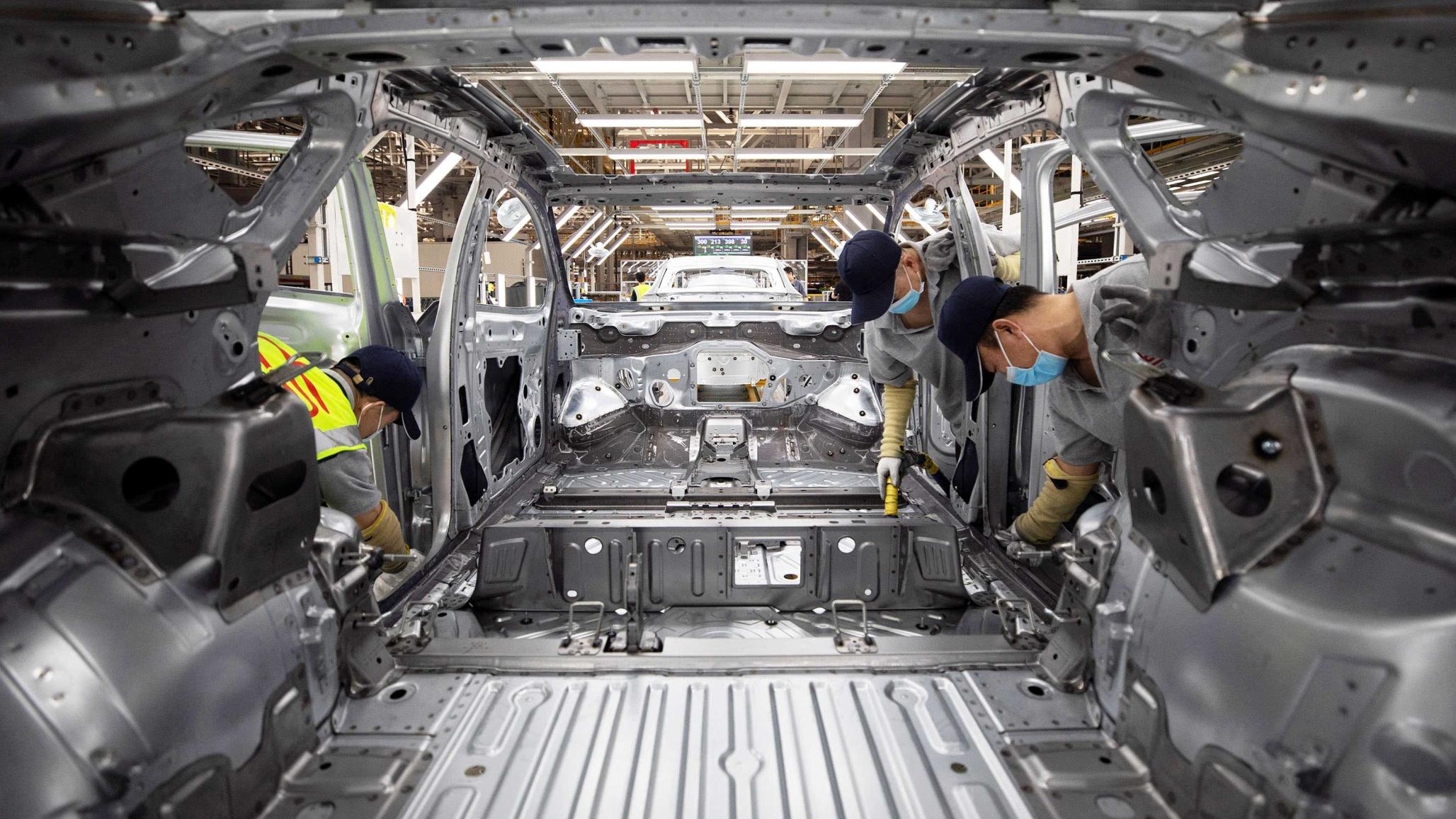Employees work on an EV production line at a factory in Hefei, Anhui province, China. September 2024. 