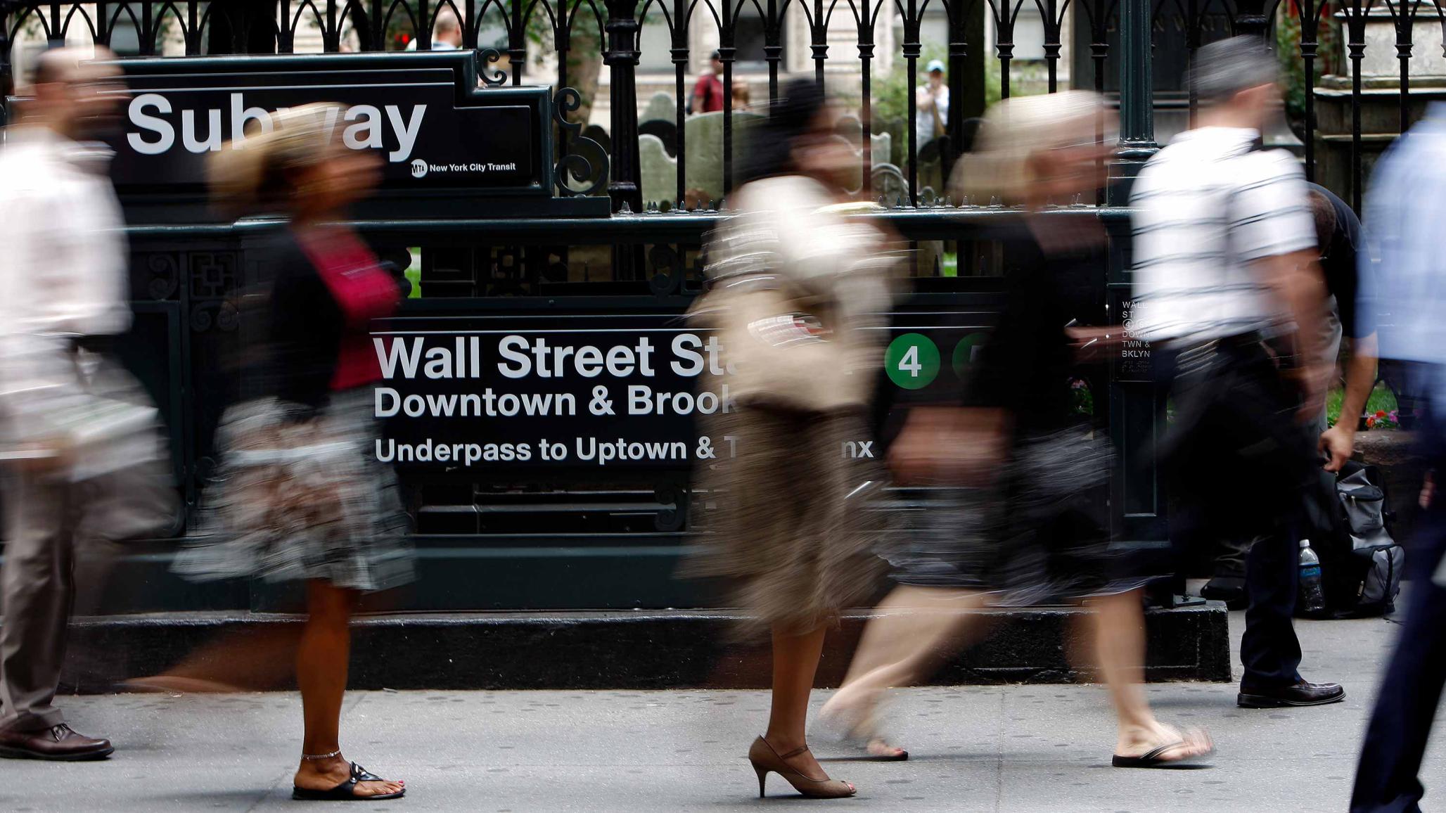 People walk down Broadway past the Wall Street subway station in New York September 15, 2008. 