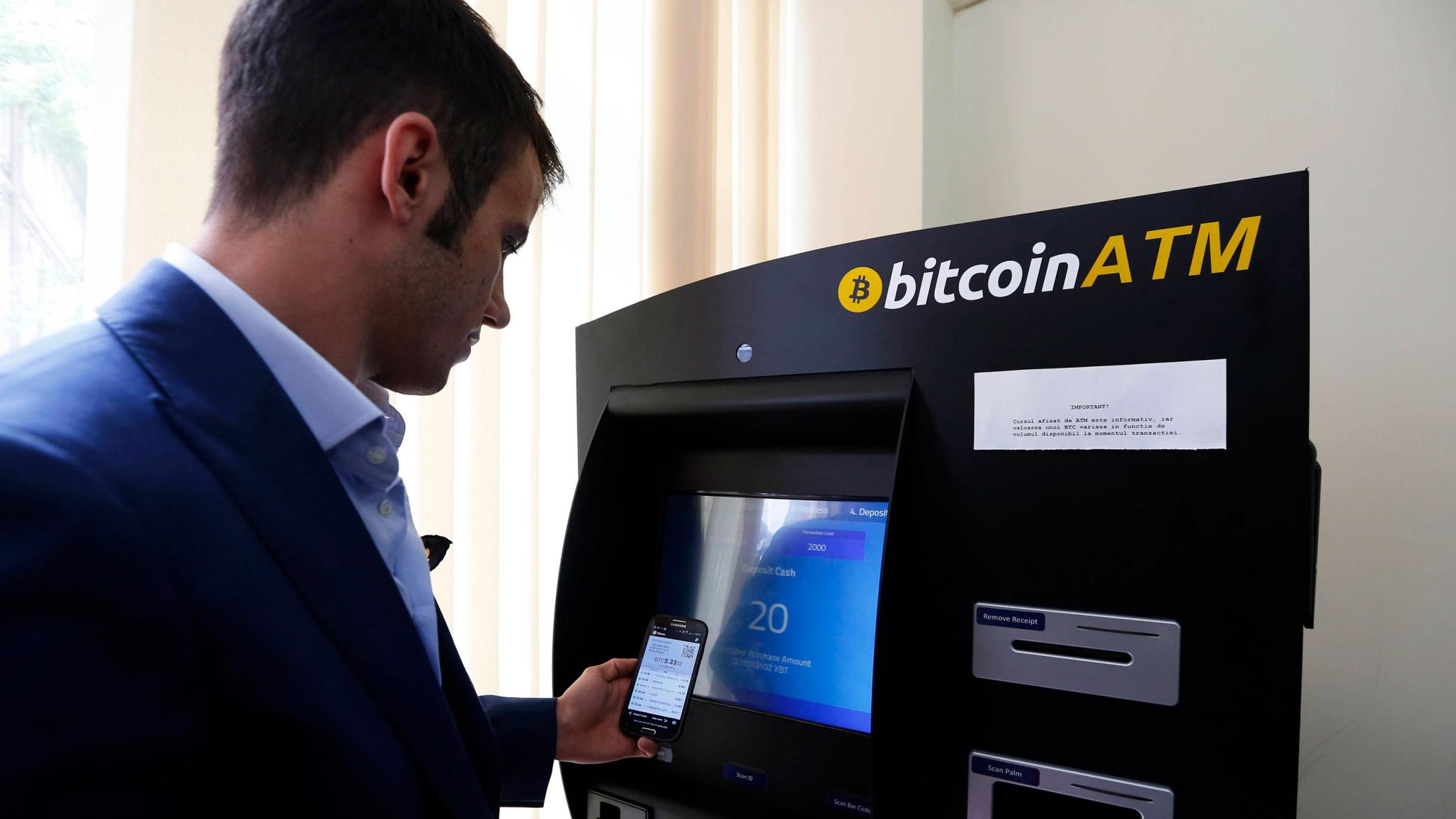George Rotariu uses the first bitcoin ATM in downtown Bucharest June 27, 2014. 