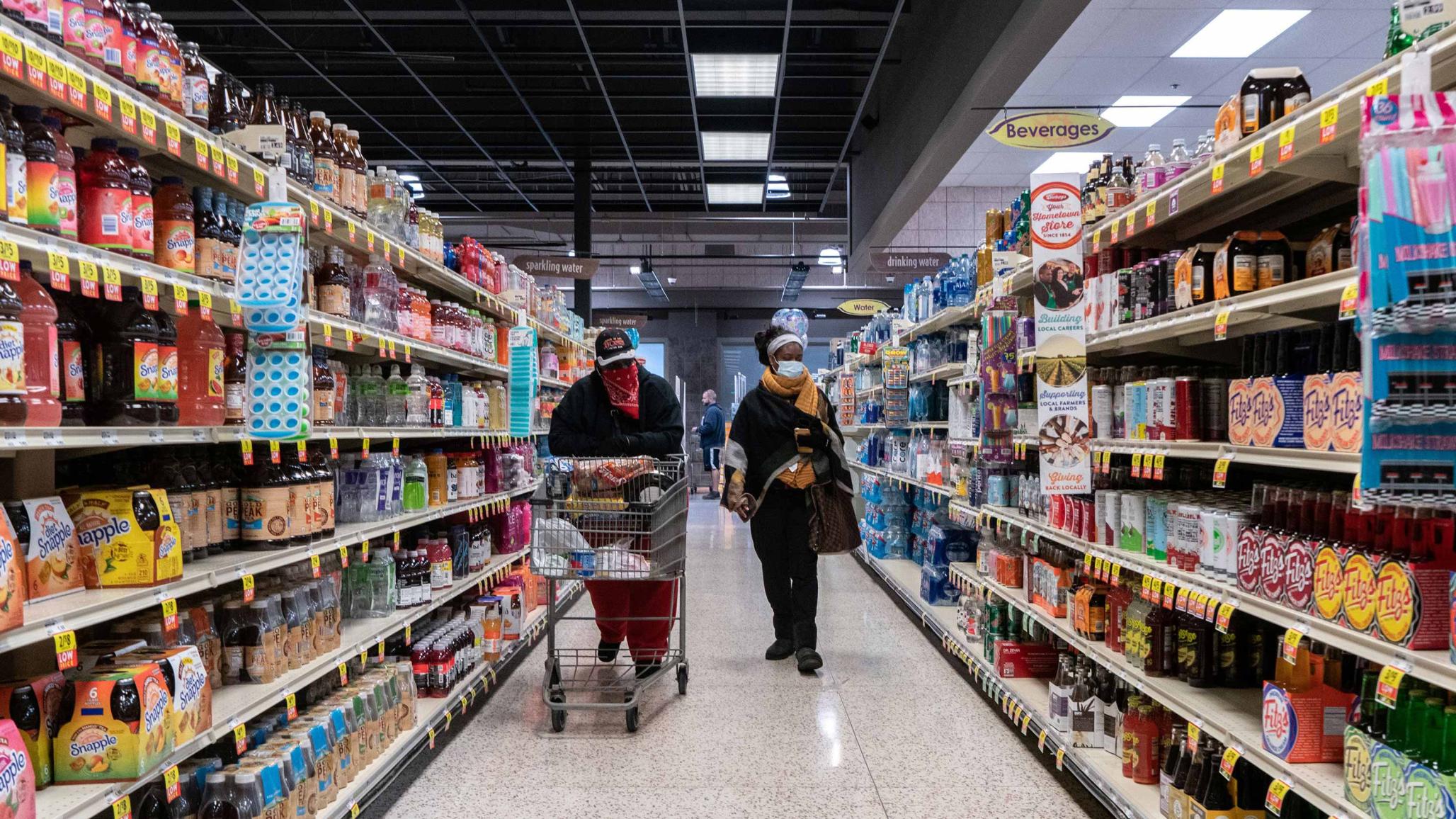 Shoppers browse in a supermarket while wearing masks to help slow the spread of coronavirus disease (COVID-19) in north St. Louis, Missouri, U.S. April 4, 2020.