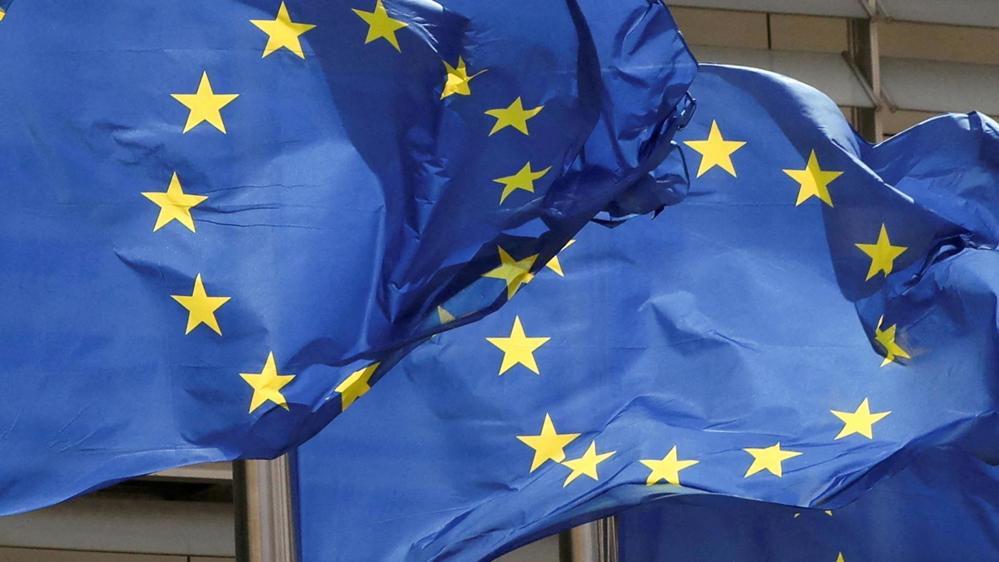 European Union flags flutter outside the EU Commission headquarters in Brussels, Belgium. 