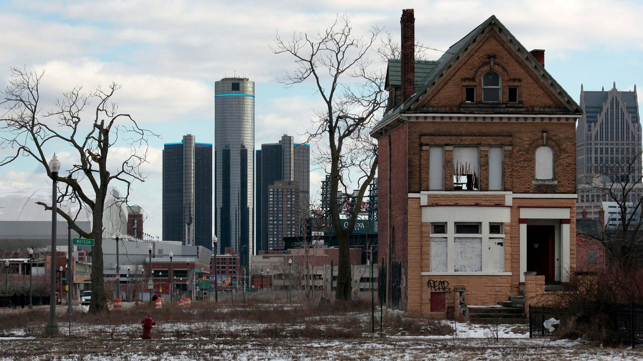 A vacant, boarded up house is seen in the once thriving Brush Park neighborhood with the downtown Detroit skyline behind it in Detroit, Michigan March 3, 2013