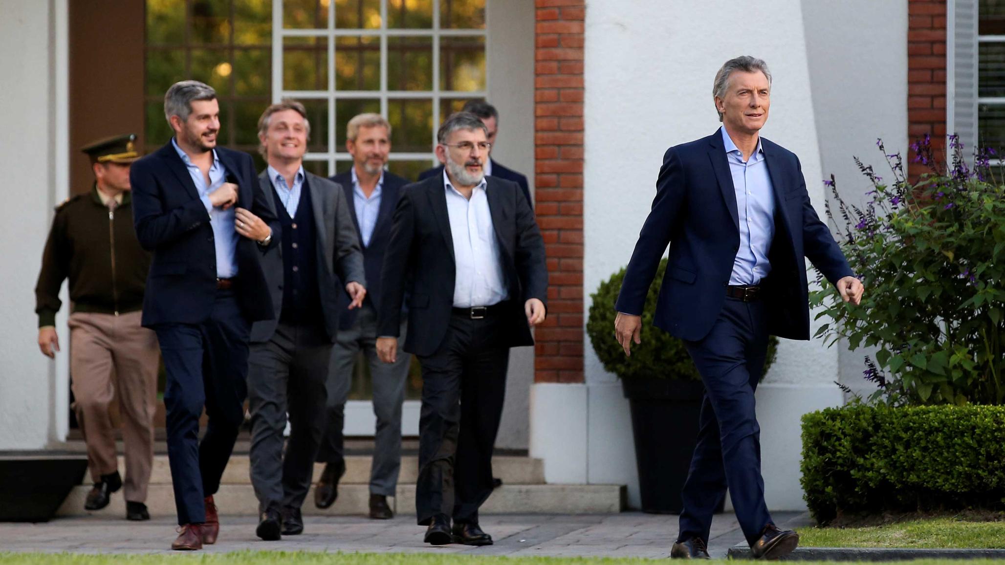 Argentina's President Mauricio Macri (R) walks to attend a news conference at the Olivos Presidential Residence in Buenos Aires, Argentina May 16, 2018. 
