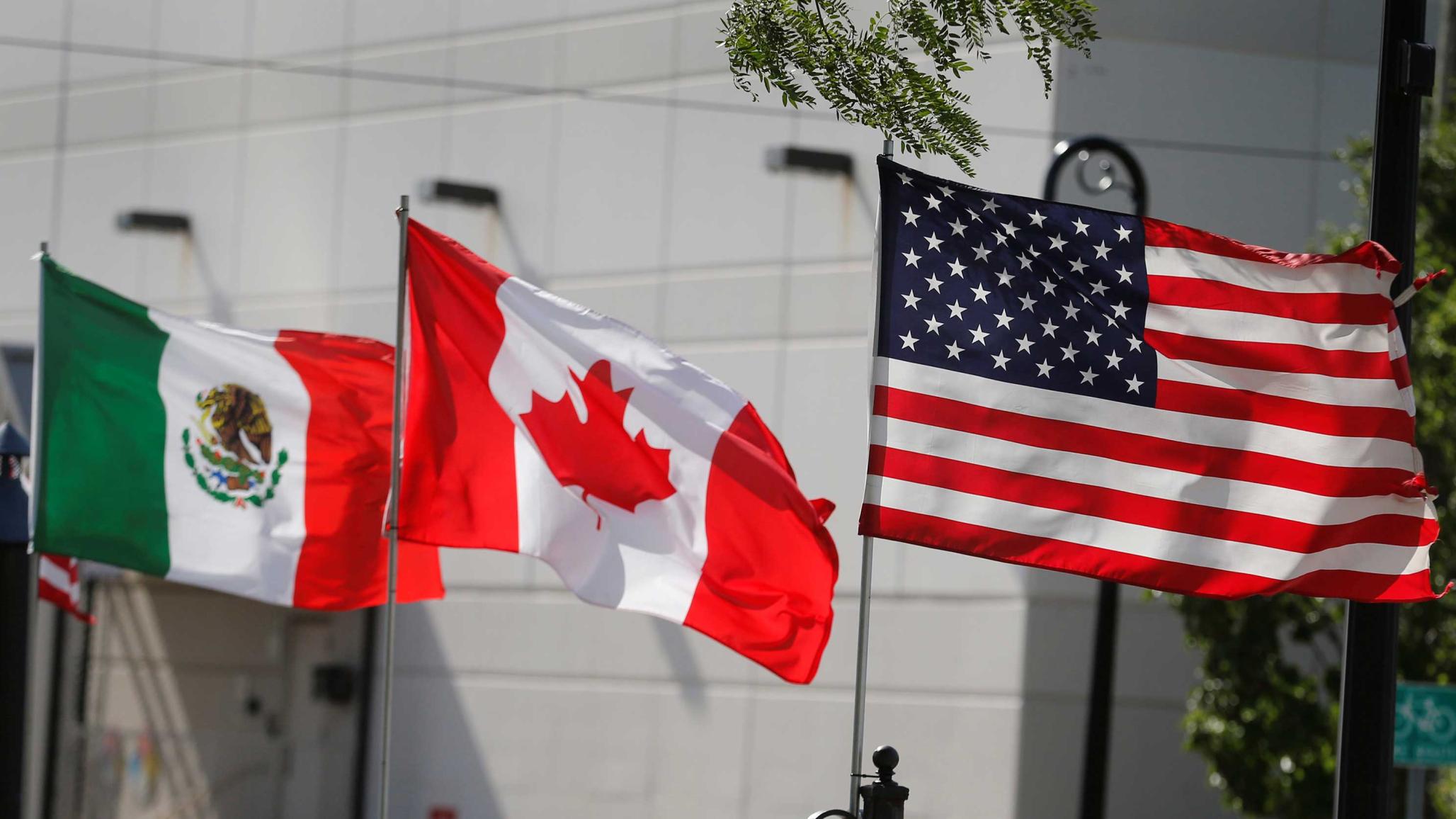 :  Flags of the U.S., Canada and Mexico fly next to each other in Detroit, Michigan, U.S. August 29, 2018. 