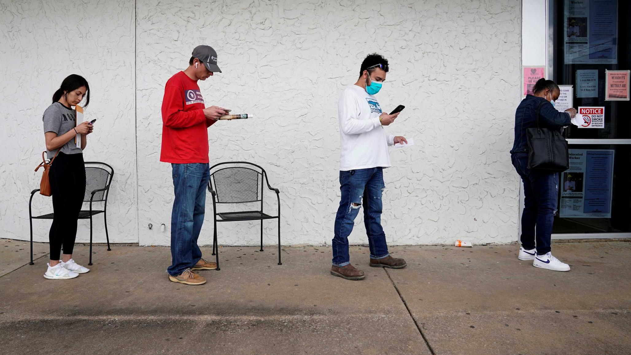 People who lost their jobs wait in line to file for unemployment following an outbreak of the coronavirus disease (COVID-19), at an Arkansas Workforce Center in Fayetteville, Arkansas, U.S. April 6, 2020. 